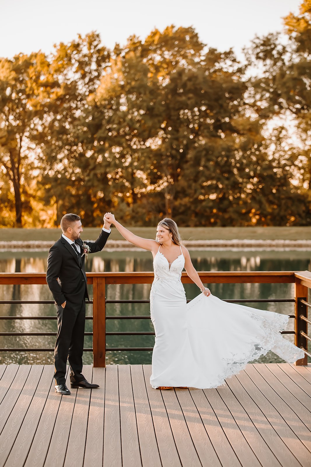 outdoor fall wedding portraits bride groom dock lake.jpg