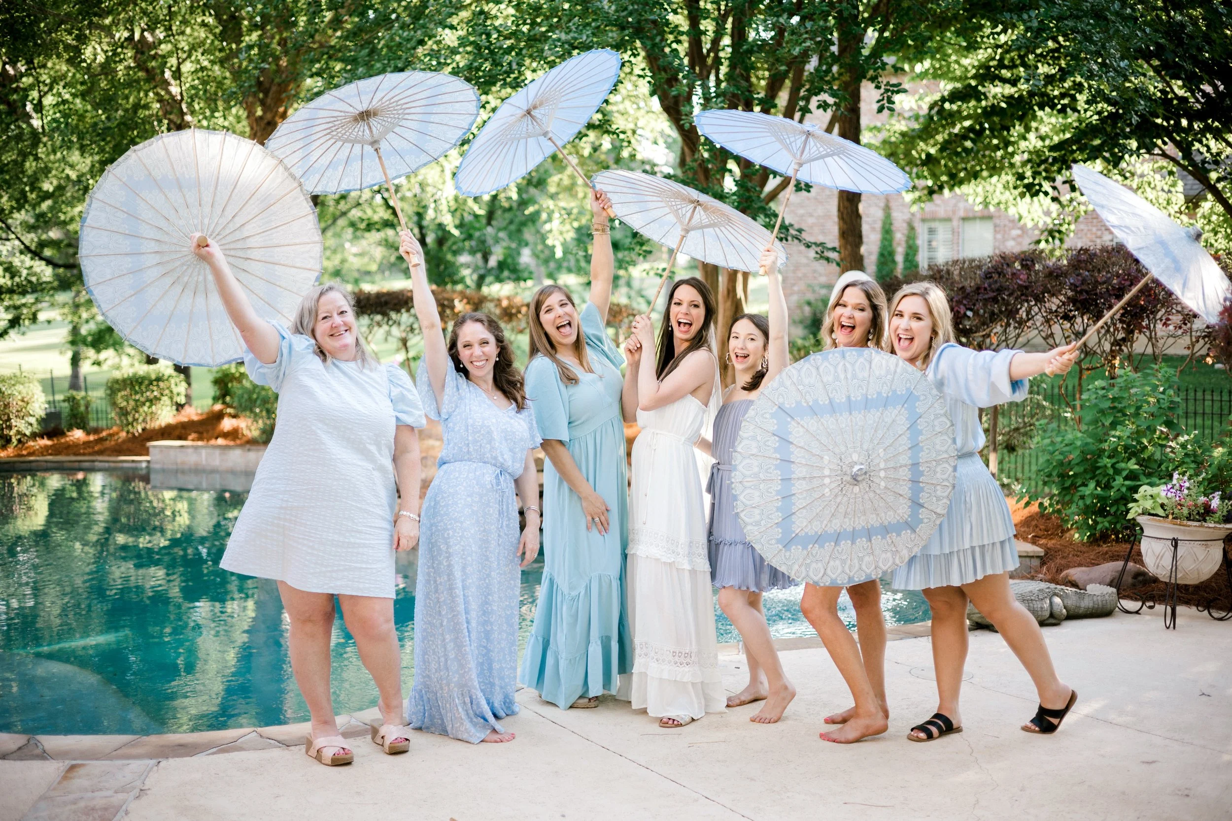 Cheers for cute umbrellas and backyard summer weddings!