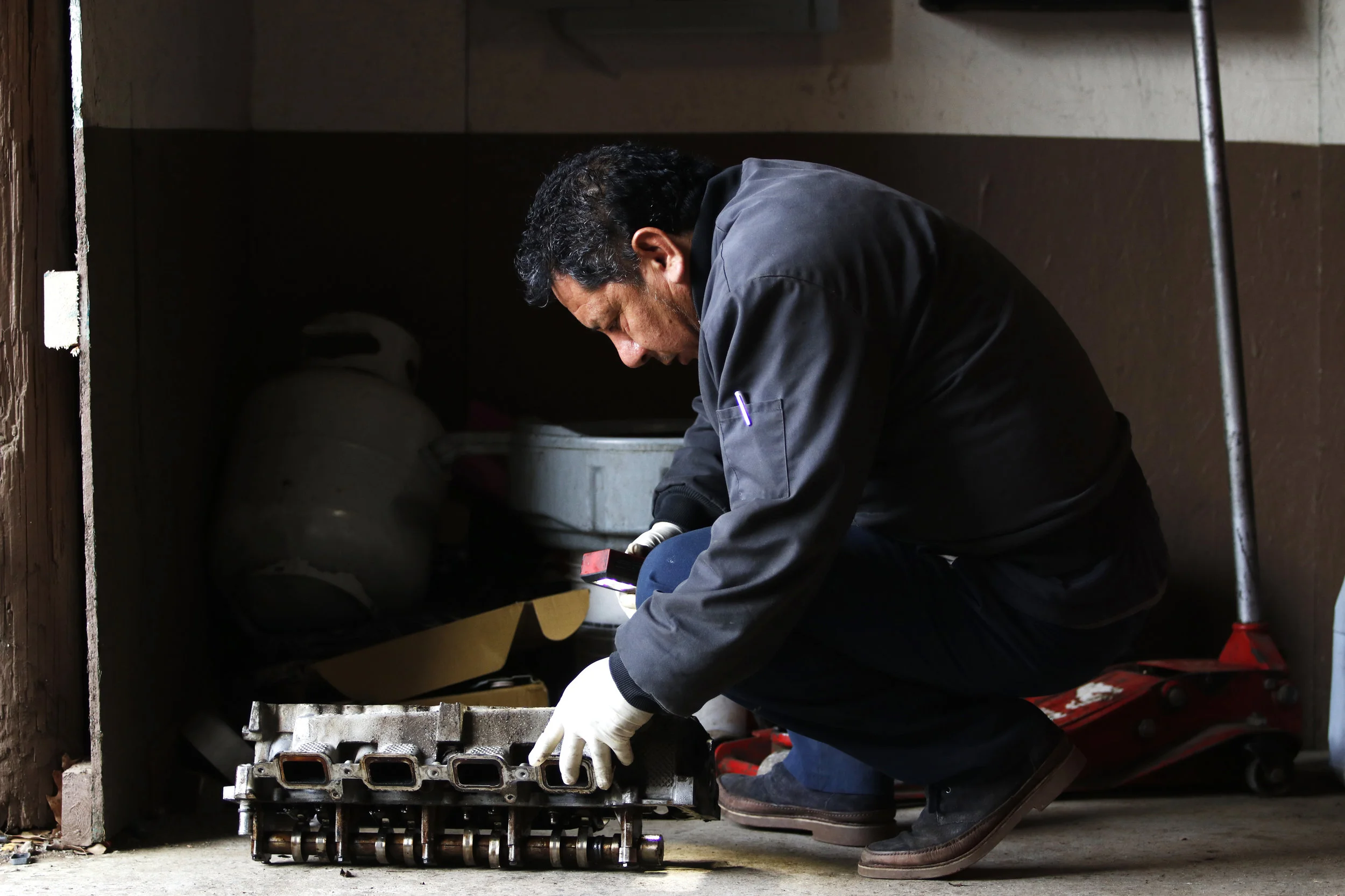  Javier Aparicio inspects a car part inside Aparicio’s Garage in Greensboro, Georgia.  