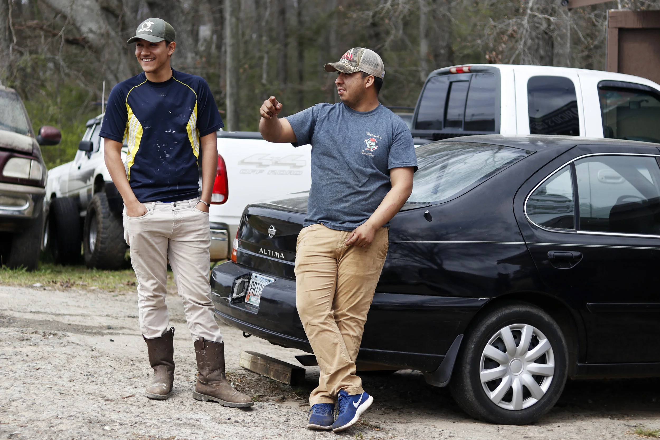  Andre Aparicio chats with a cousin at the end of the work day at Aparicio’s Garage in Greensboro, Georgia.  