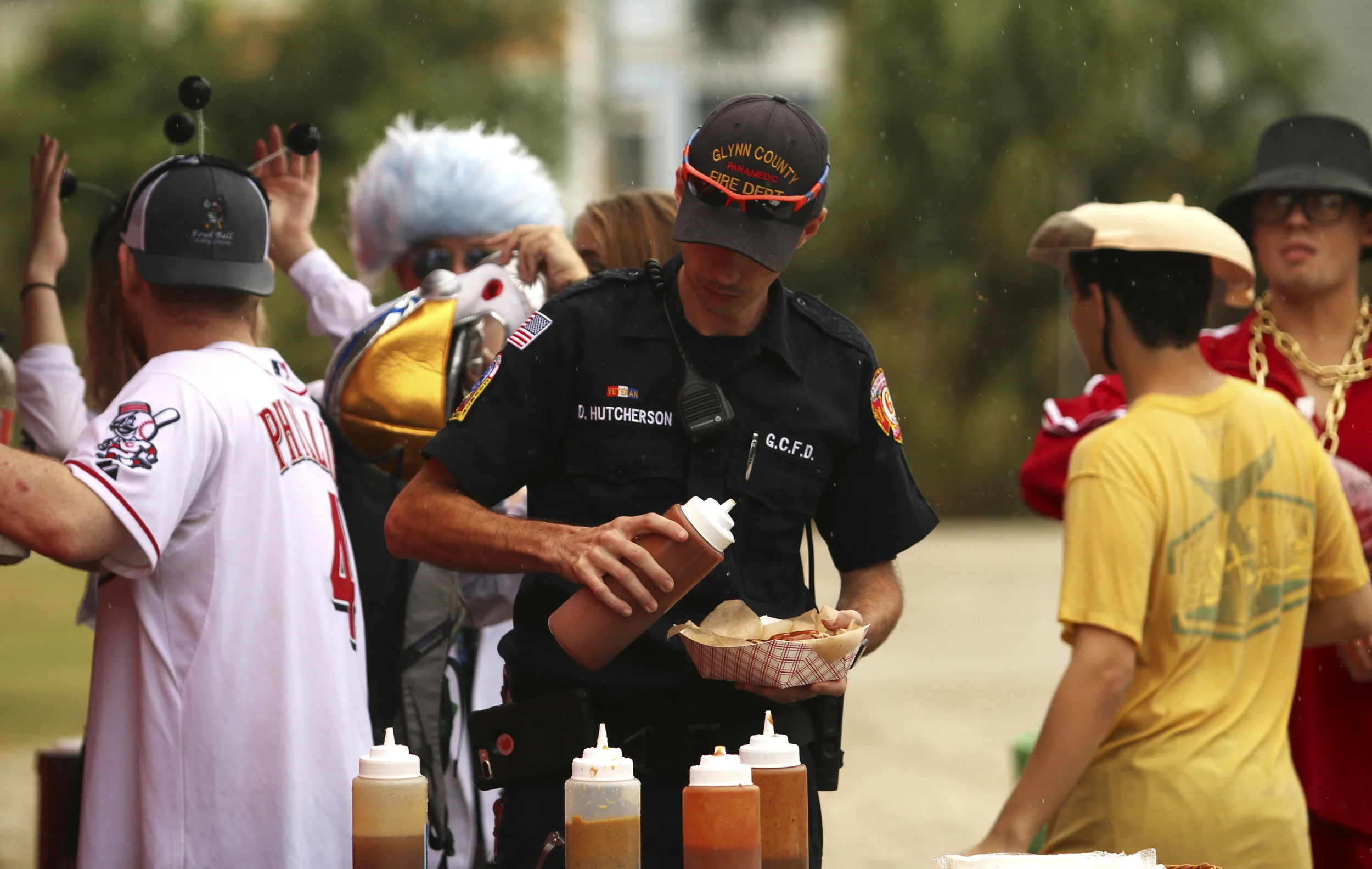  A local firefighter prepares a hot dog at a food truck in the East Beach parking lot. Food trucks made their first appearance at the event in 2018. 