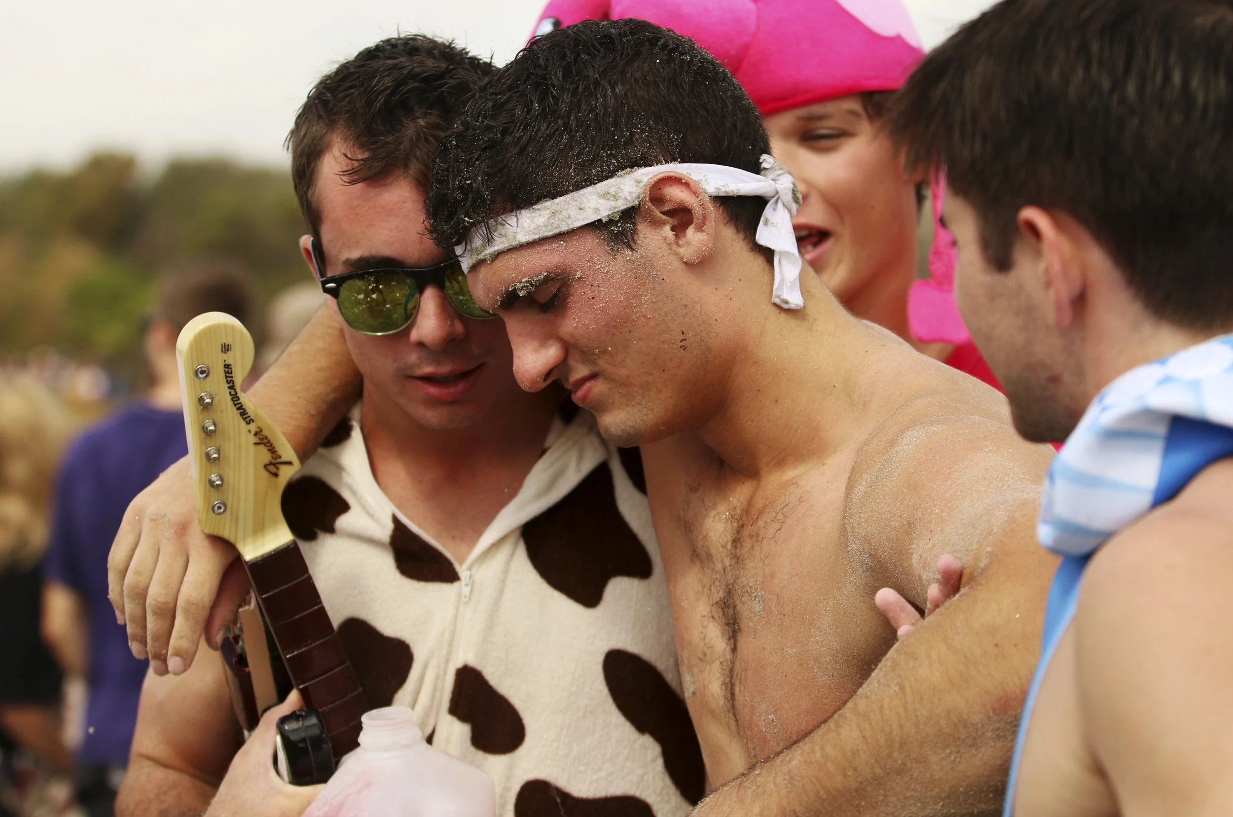  Students help their friend off the beach and into an Uber. Drinking is a large part of the event, and first aid tents go up along the beach to assist the intoxicated. 