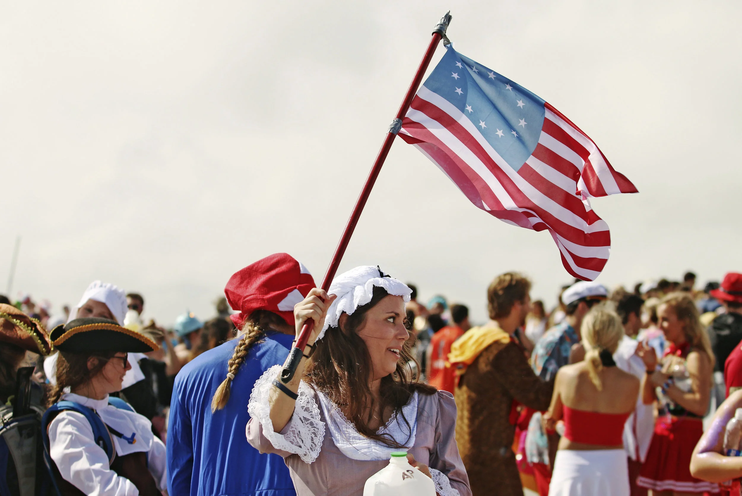  A woman dressed as Betsy Ross waves an American flag. 
