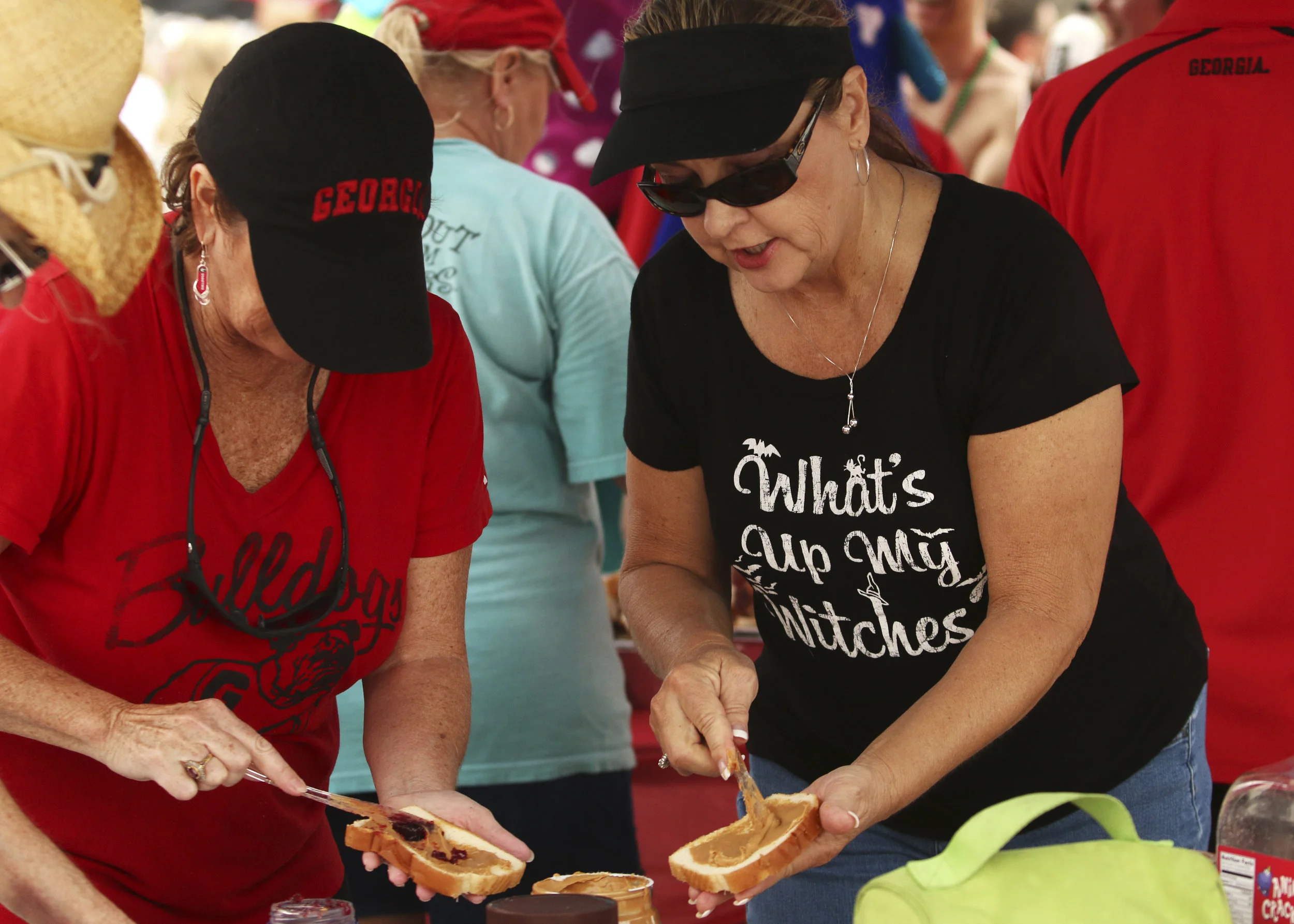  Local women prepare peanut butter and jelly sandwiches for attendees. 