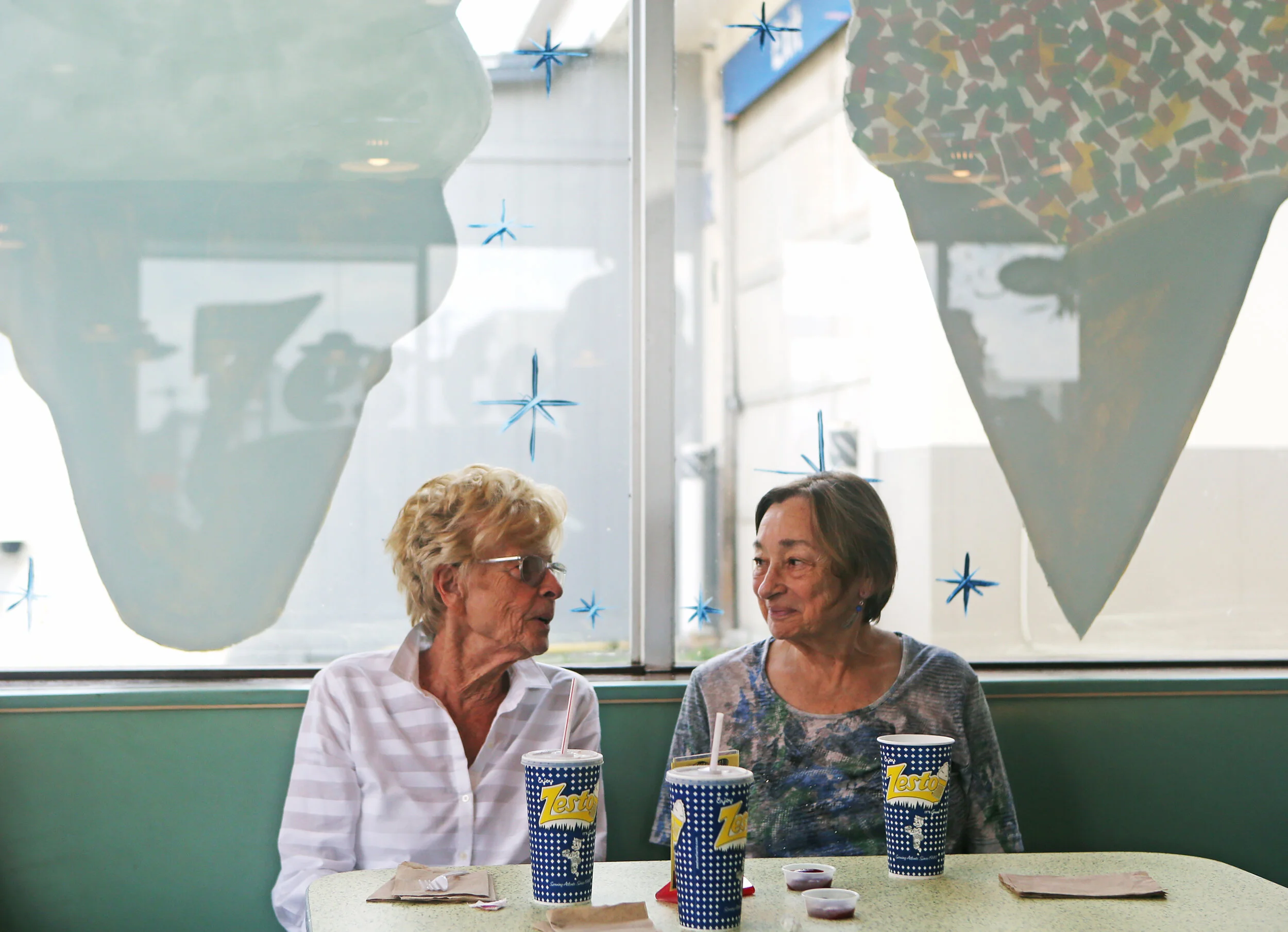  Two Zesto customers who wished not to be named enjoy their drinks during the 70th anniversary celebration for Zesto Atlanta on Monday, July 1, 2019. Zesto celebrated its 70th anniversary with 70 cent chili dogs for its customers, who packed the rest