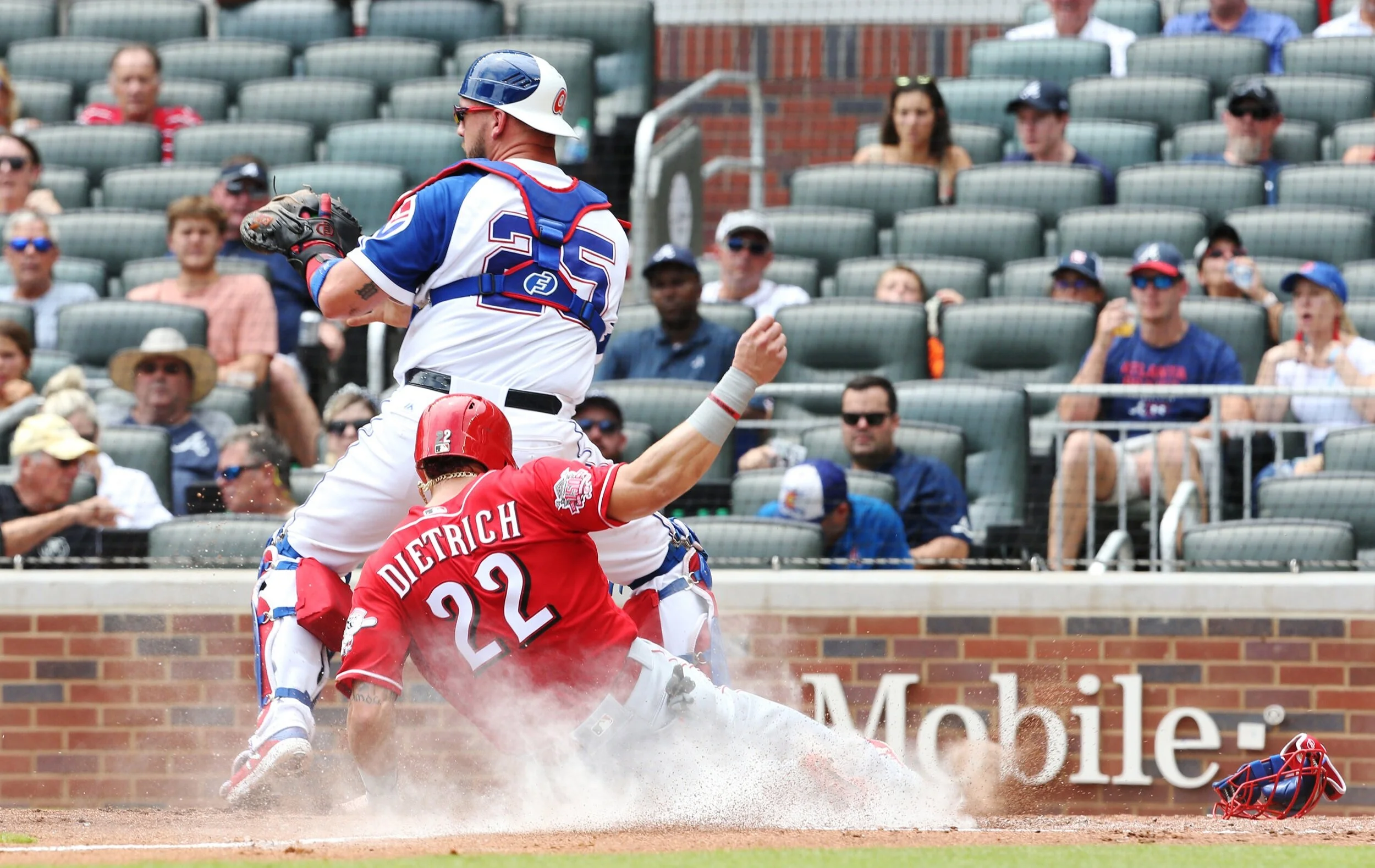  Cincinnati Reds infielder Derek Dietrich slides into home to score a run during the Atlanta Braves vs. Cincinnati Reds baseball game at SunTrust Park on Sunday, August 4, 2019. The Reds defeated the Braves 6-4. 