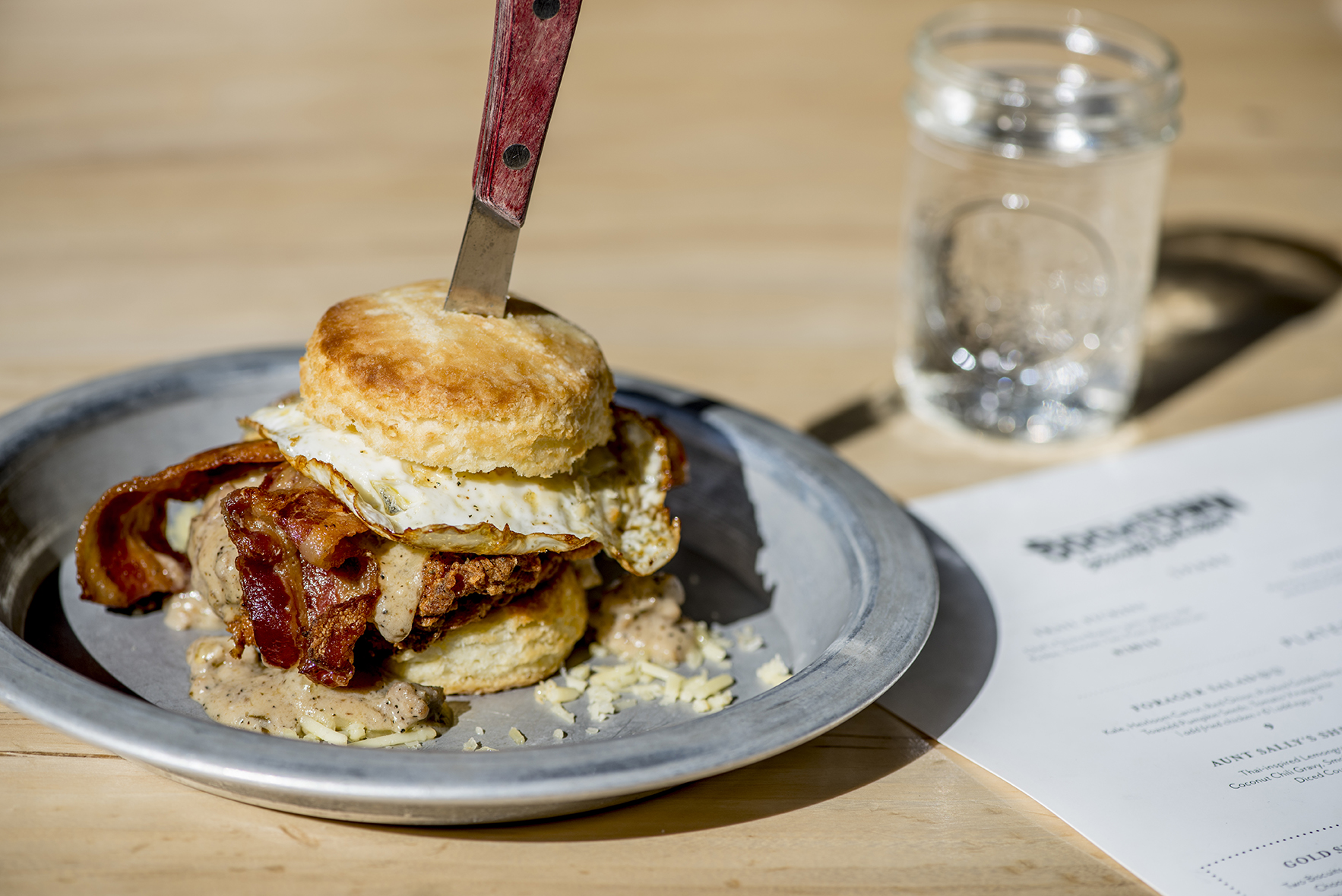  A favorite at  Boomtown Biscuits &amp; Whiskey . The Yukon - Fried Chicken, Sawmill Gravy, Smoked Cheddar, Bacon and Egg add-on. || Image:  Twin Spire Photography  - Published: 10.9.2019 