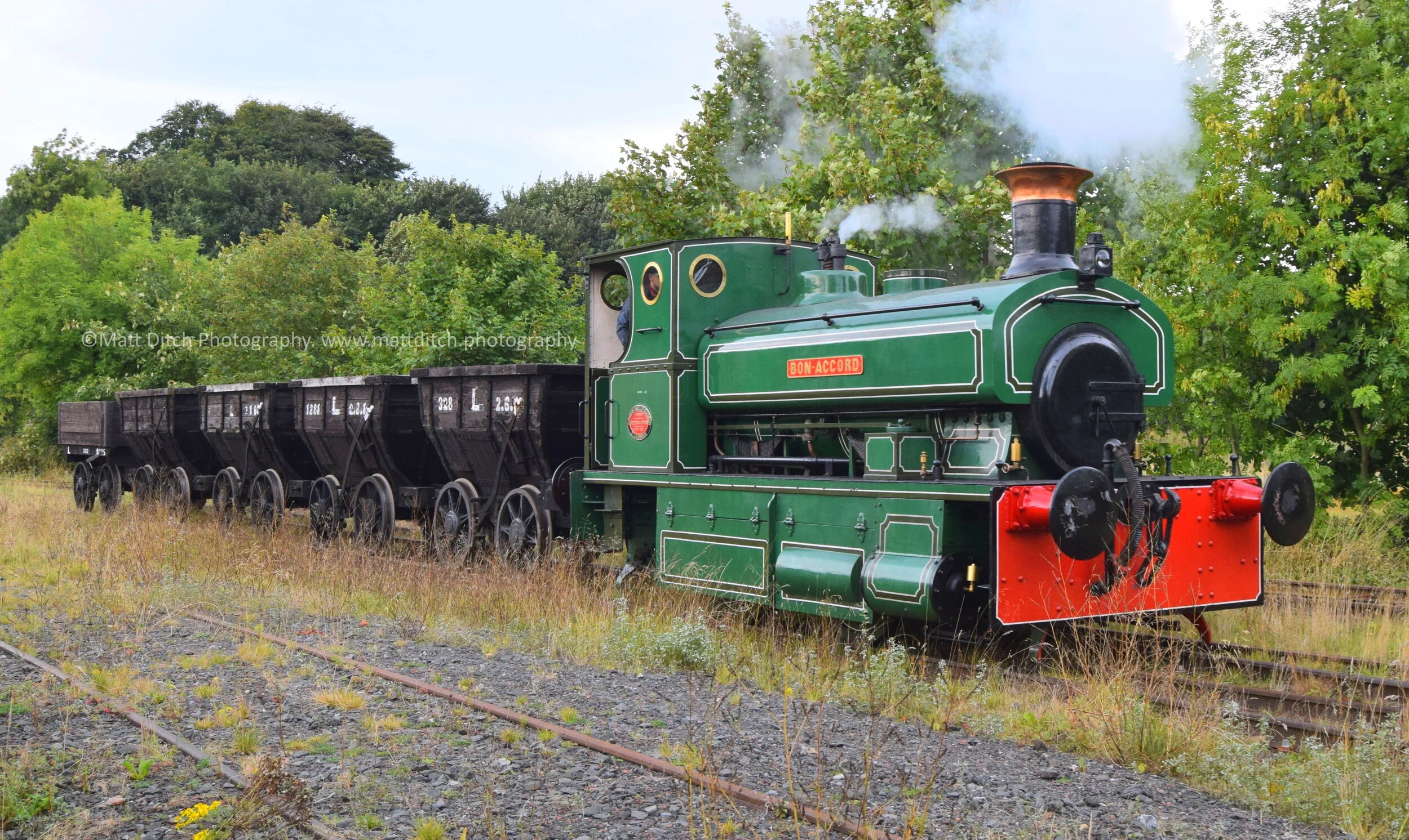  Heading past the miners cottages with a rake of Chaldron wagons.  