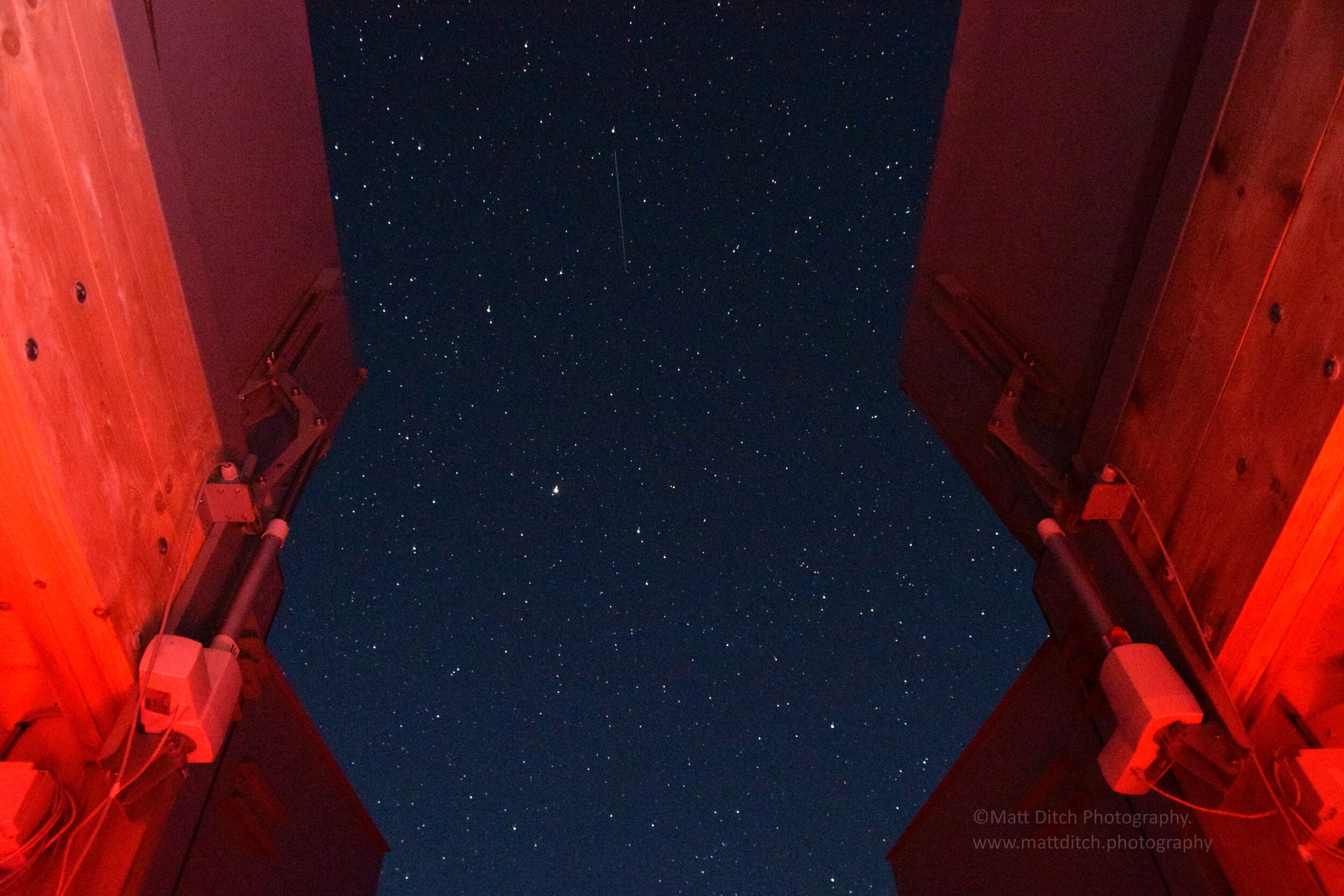 Looking up at the night sky from the base of the telescope.
