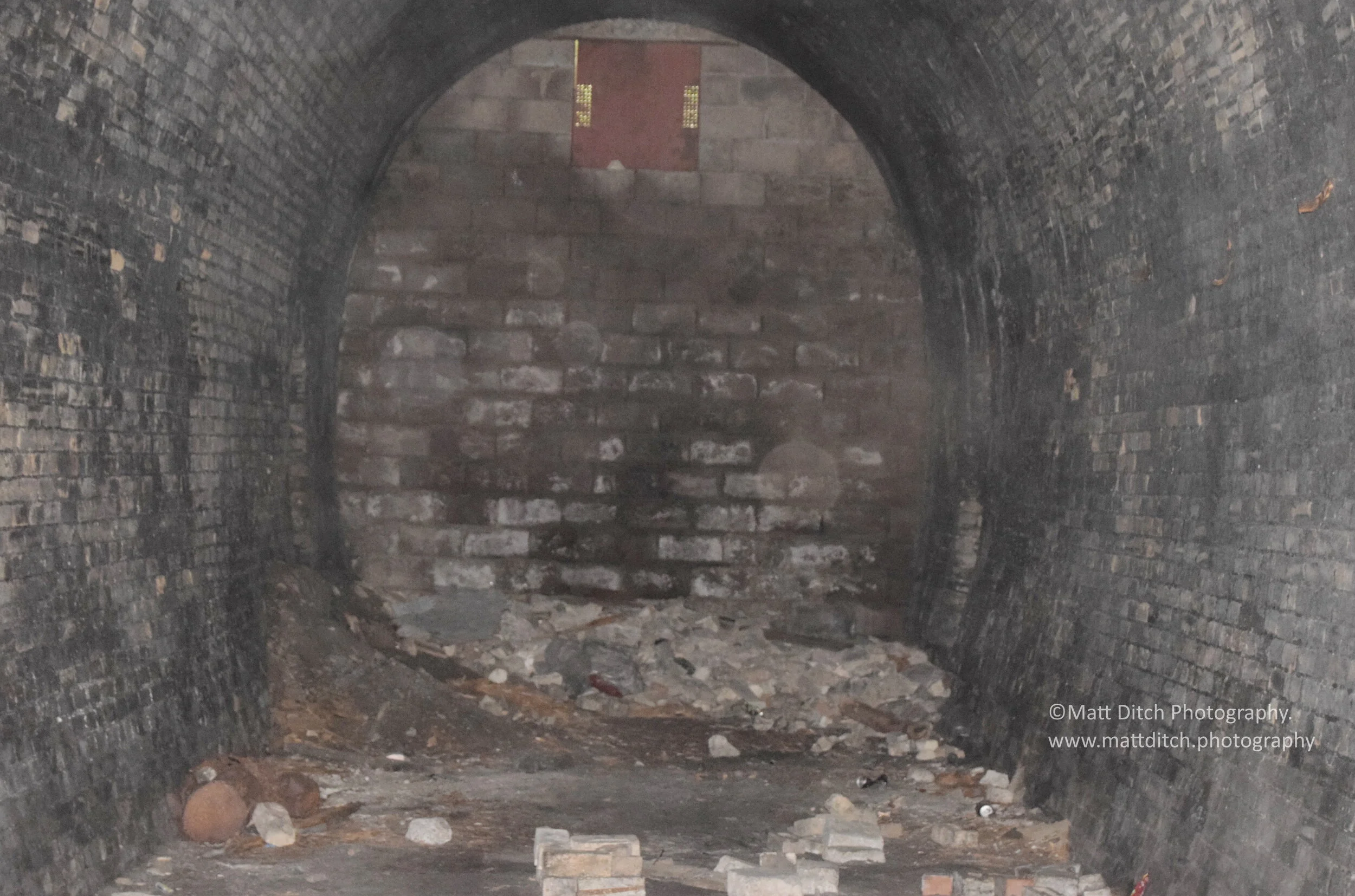  Looking into the tunnel. The cutting the tunnel opened out into has been filled in up to just below the hatch at the top of the arch. The Colliery was on the left-hand side of the tunnel.  