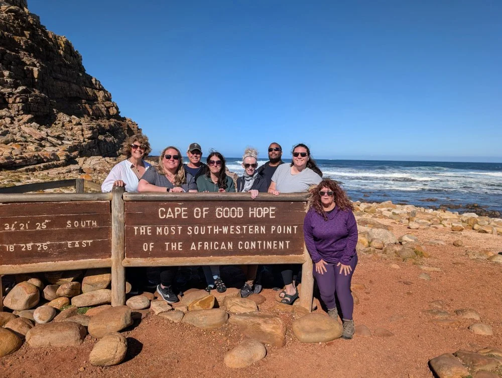 The Travel With Anne group poses at the Cape of Good Hope South-Western most point sign