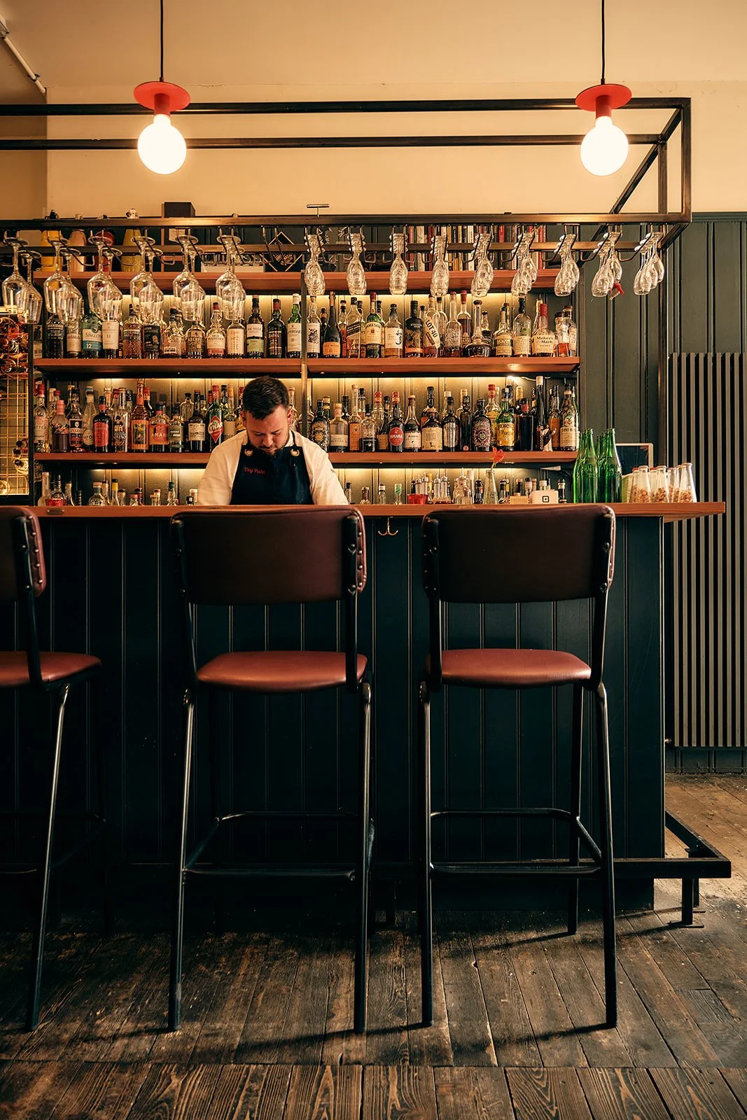 preparing cocktails behind the bar at Hey Palu in Edinburgh.