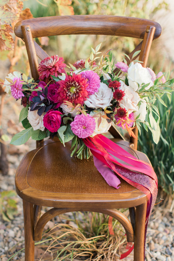 Pink and white bouquet on wooden chair