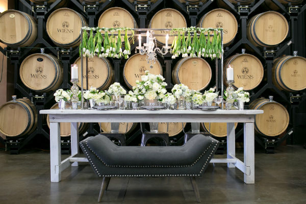 Head table with bench seat in front wall of barrels