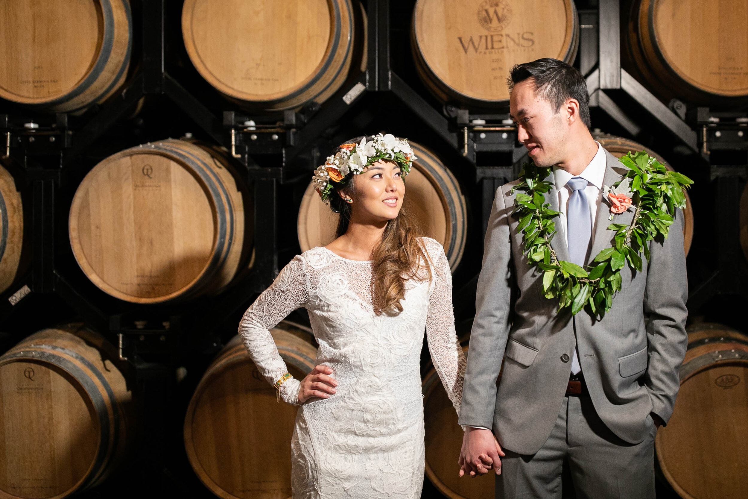 Bride and Groom in front of stacked barrels