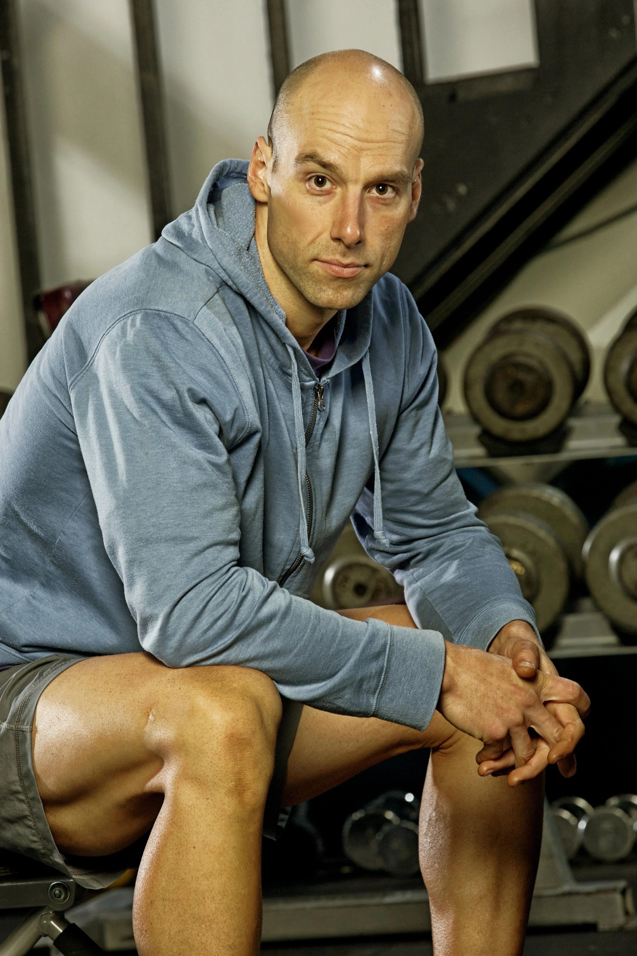 John Fawcus sitting down on a bench looking at the camera.