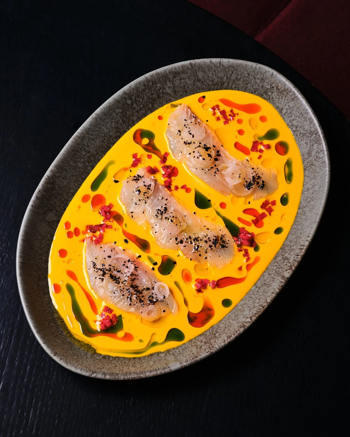 Amazing art on the walls and canvas of color and flavor on the plate. The Fluke Crudo with carrot aguachile, tomato gel&eacute;e, urfa, and piment&oacute;n offers a perfect start to your meal at the elegant @metropolisbymarcus.