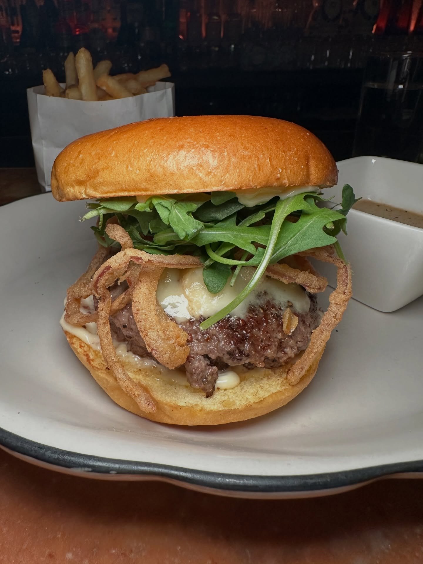 The Burger from @casathirteennyc 

Peppercorn-seasoned patty, Roquefort cheese, fried onions, arugula, and mayo between a Balthazar brioche bun, served with a side of peppercorn Au Poivre sauce. 

Officially verified as one of the best in NYC by Mike