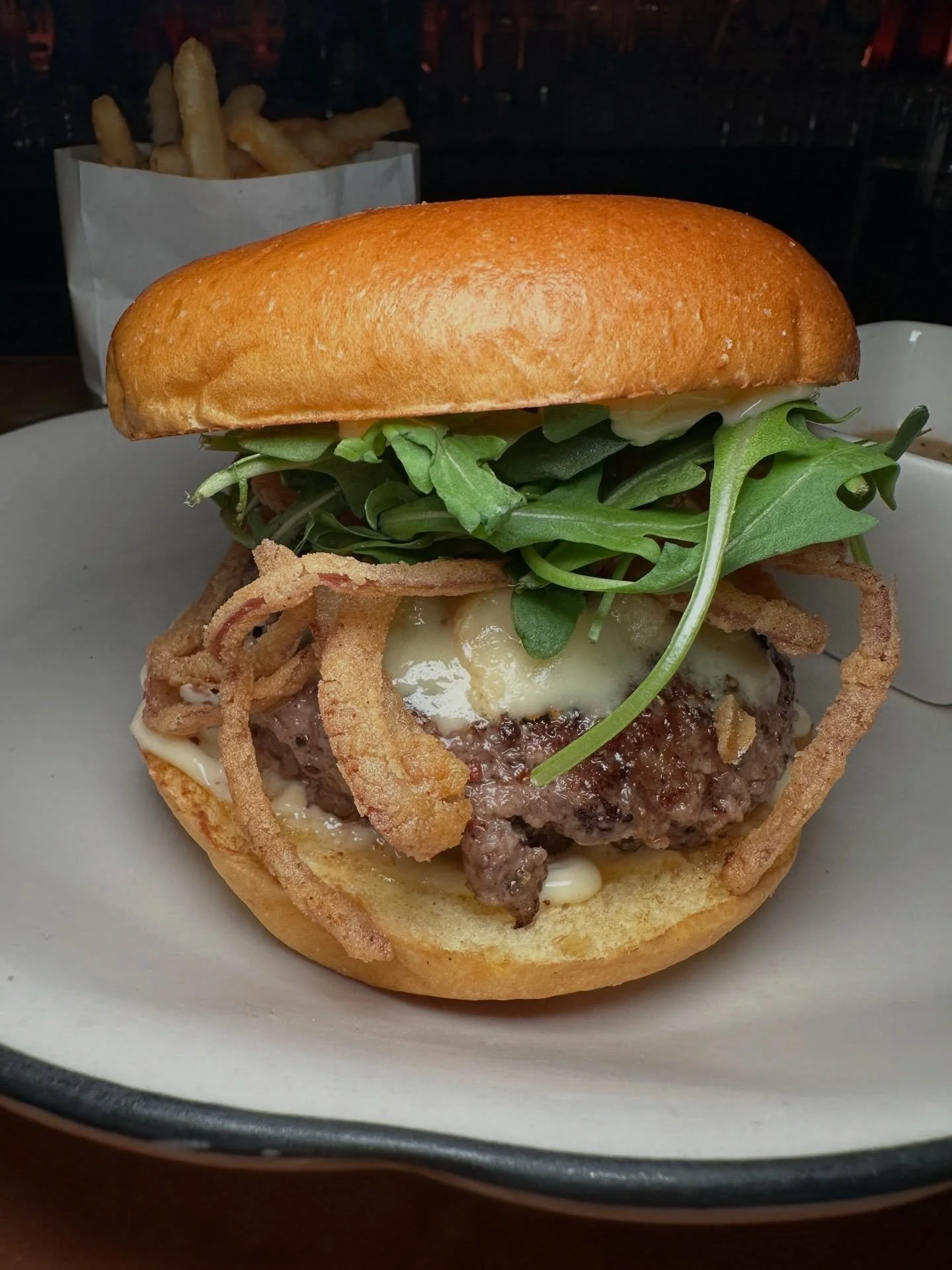 The Burger from @casathirteennyc 

Peppercorn-seasoned patty, Roquefort cheese, fried onions, arugula, and mayo between a Balthazar brioche bun, served with a side of peppercorn Au Poivre sauce. Rich, creamy, and decadent.

Officially verified as one