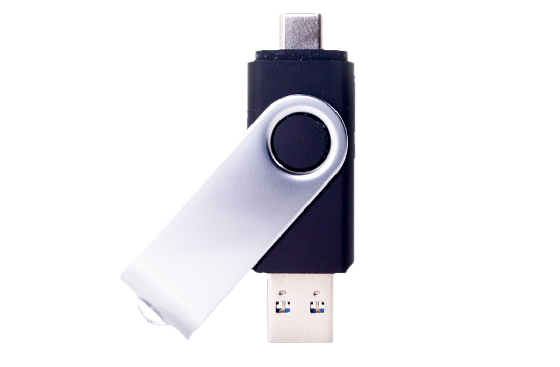 A USB security key, with a black and silver design, connected to a computer.