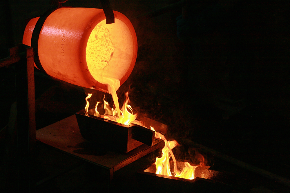 Molten gold being poured into ingot moulds