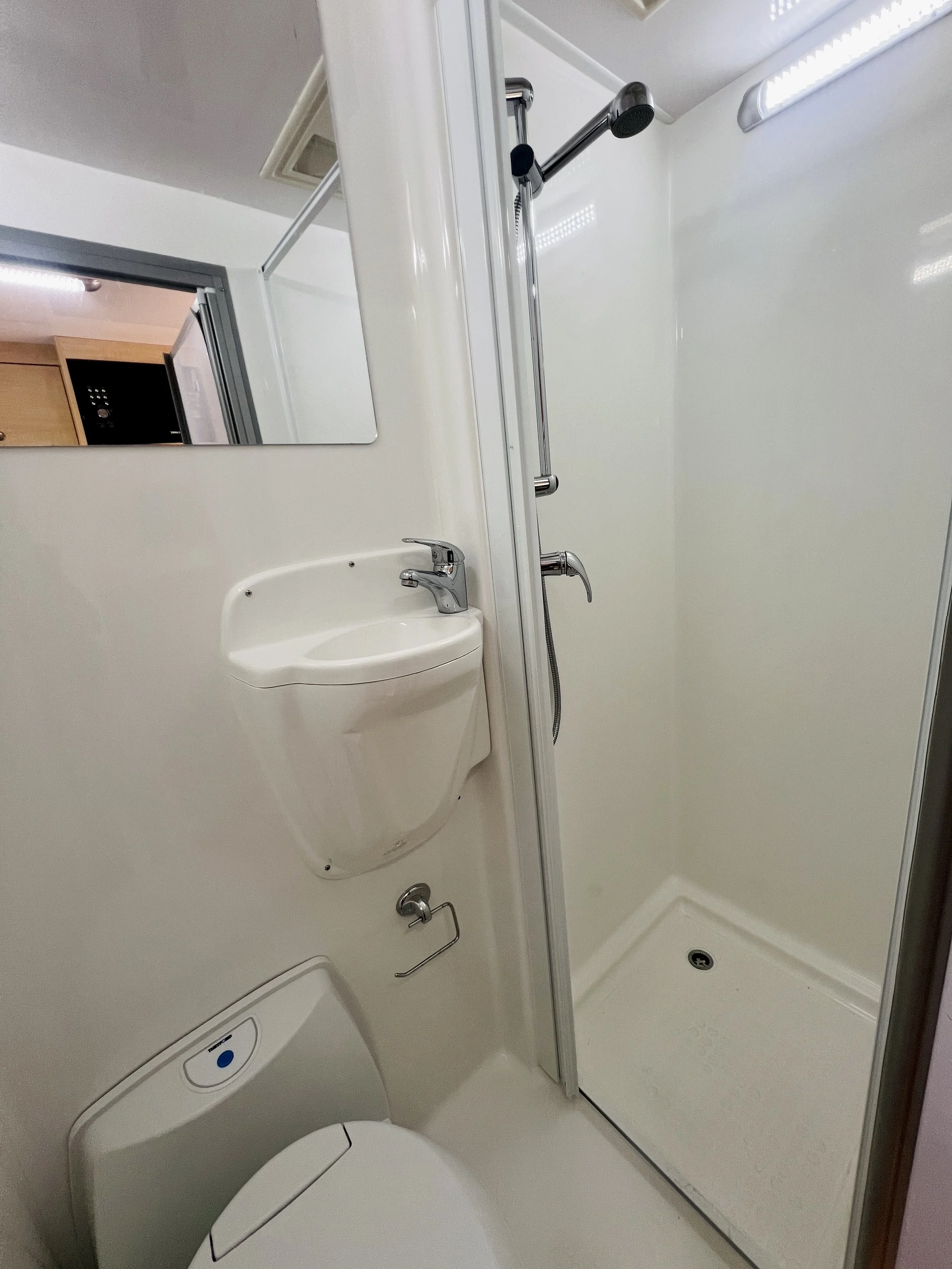 Internal bathroom in the Leo motorhome with hot water shower, toilet and hand basin, fully self-contained