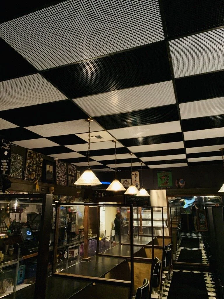 The egg-crate ceiling tiles at 5 Point Cafe allow for airflow created by fans pulling air upward into a zone with UVC lights.