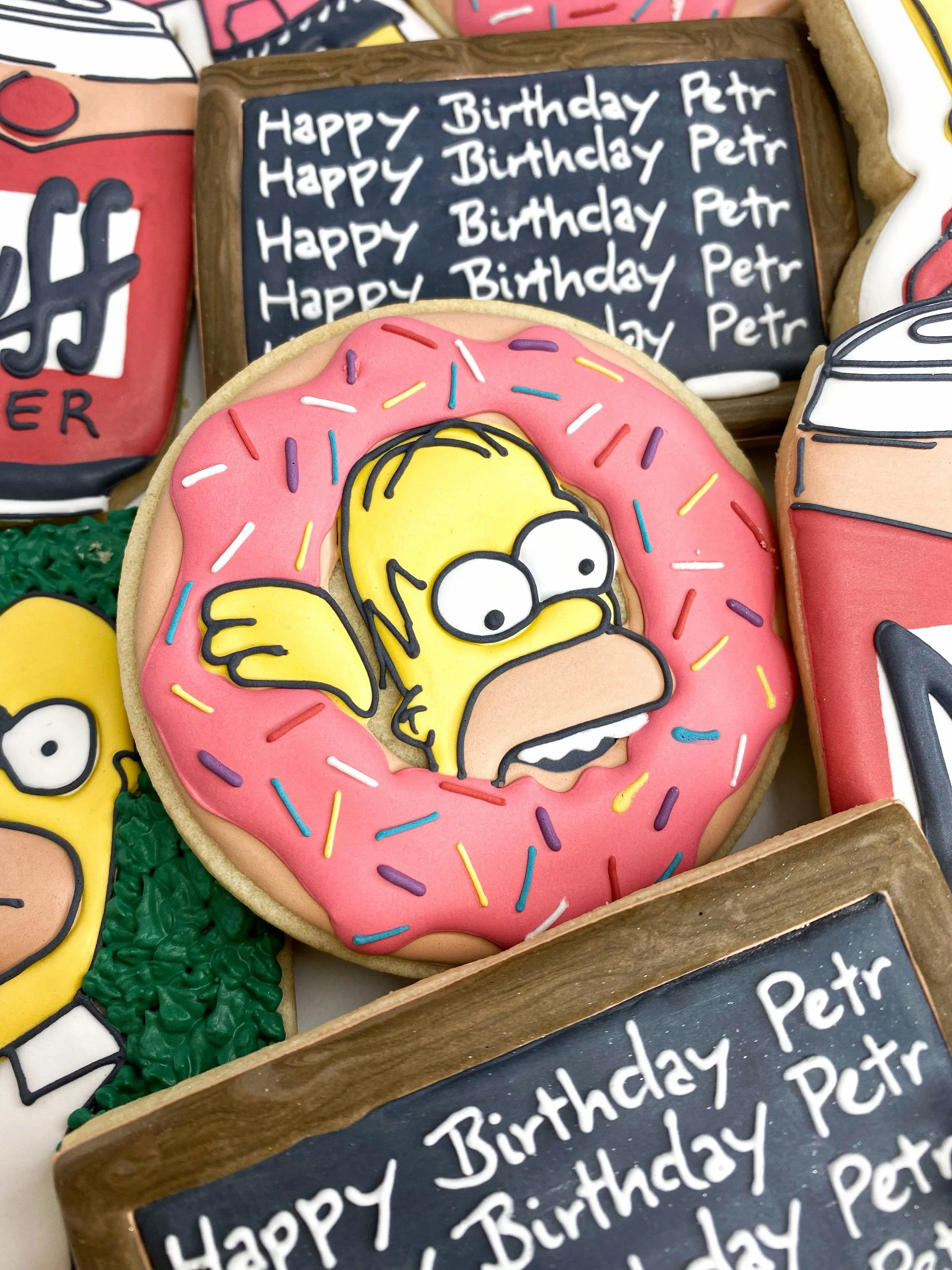 Made it through the work week &mdash; powered by deadlines and donuts. *Slams laptop shut till Monday* 🍩🤓 

Link in bio to book May before the calendar fills up!

#thesimpsonscookies #tampabaker #customcookiestampa #decoratedcookies #donutcookies