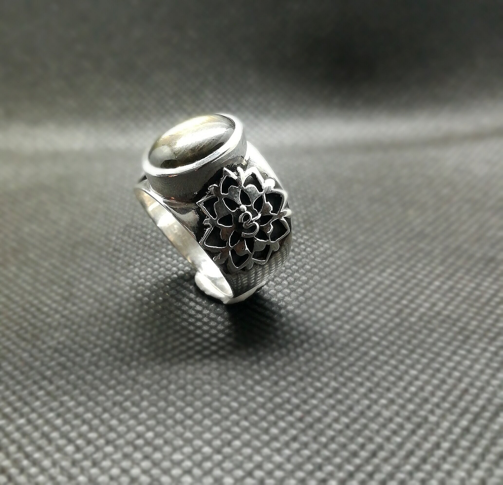 Tattoo ring, handmade for Clément. This ring is a representation of the client's 2 tattoos, surrounding a beautiful black star sapphire found while traveling, made in 925 silver. 2017-Click on the image to see detailed photos-