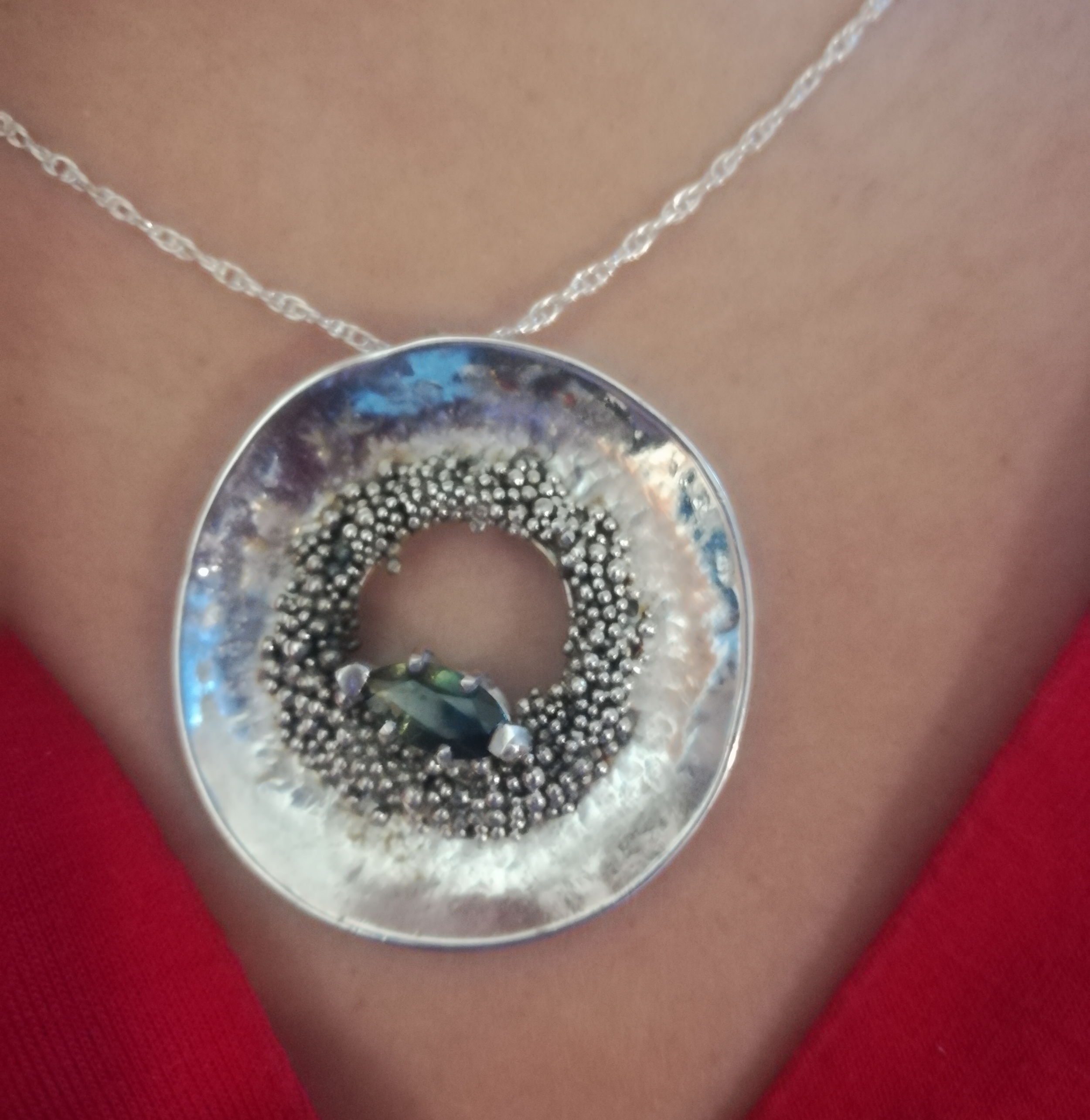 Granule pendant, made for Maggie. Granulation is an Etruscan technique that involves fusing small metal balls. The pendant is hand forged, in silver 925, size 60cm. The stone is a wonderful sapphire that changes from yellow to blue. 2018.