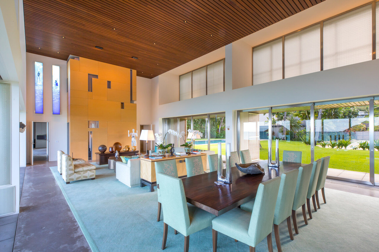   Each end of the living space is anchored by a stair tower, enclosed in a  bleached ash wall with cutouts that allow for glimpses into the space.  Tinted skylights over the stairs give a blue cast to the space. The  dining table chairs are custom ma