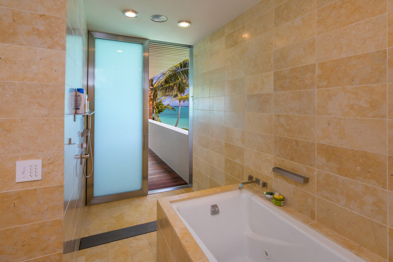  The master bathroom is lined with gold Jerusalem limestone. The fixtures are by Dornbracht.  Hiep Nguyen/Slick Pixels Hawaii 