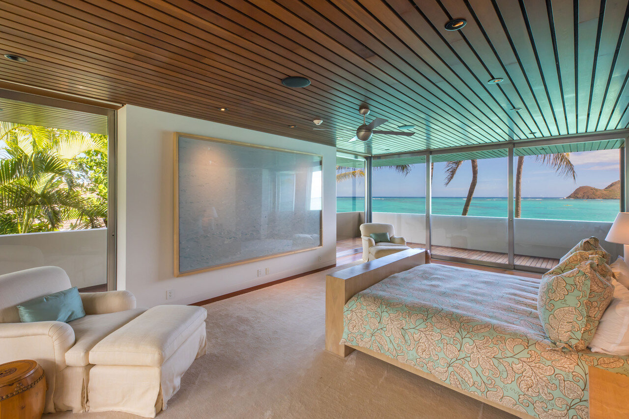    In one of the two master bedrooms hangs a large photograph by Richard  Misrach from his “On the Beach” series. The custom bed designed by  George Marshall Peters and made by Fairtlough features a TV lift  concealed in the footboard.  Hiep Nguyen/S