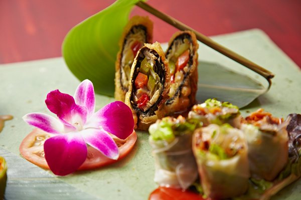 Korean wraps with edible flower on plate