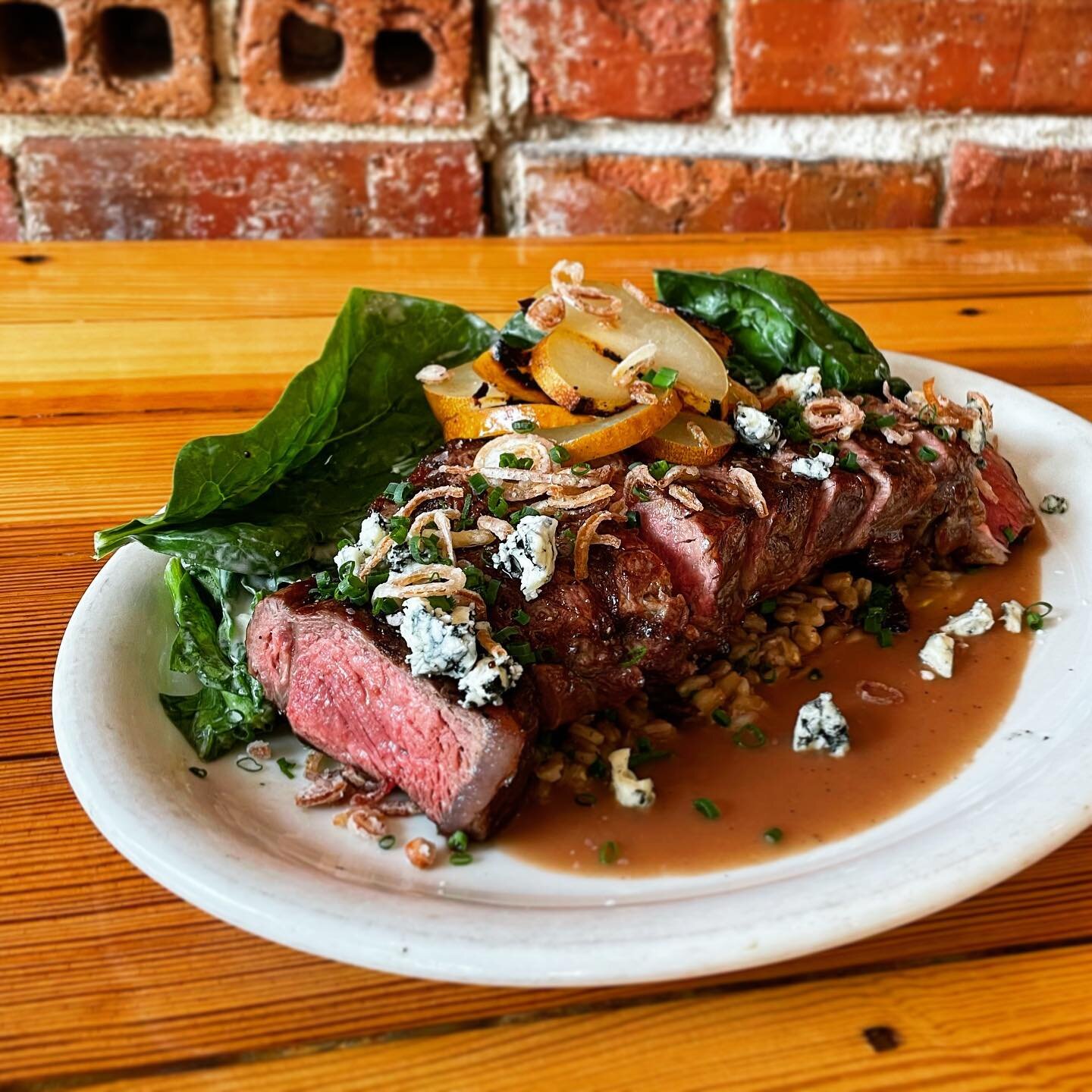 Grilled NY strip, 13oz. There&rsquo;s other stuff on the plate (e.g. roasted Asian pears, blue cheese, farro) but who even read past the first line?? Pairs beautifully with red wine, or a fine sipping bourbon like our new Pappy Van Winkle 12yr! Come 