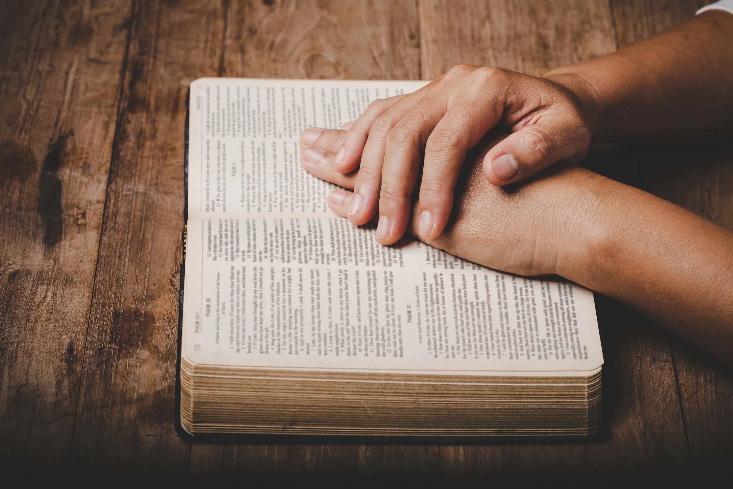 close-up-of-christian-woman-hand-on-holy-bible-are-pray-and_10195836.jpg