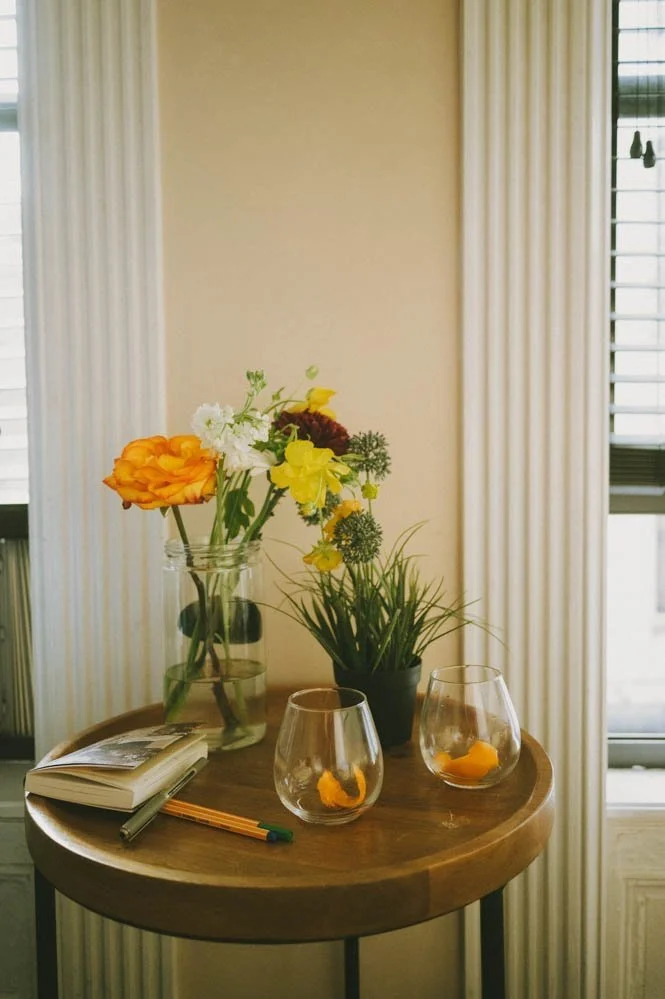 Person journaling in a notebook with tea beside them, representing low-energy creative activity for chronic illness