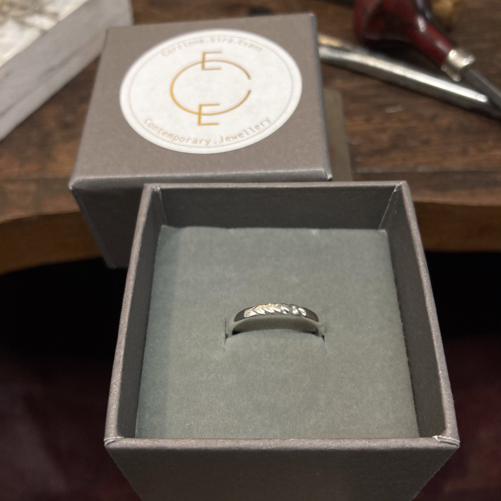 Bespoke made wedding ring in silver with hand carved 'Feather' pattern