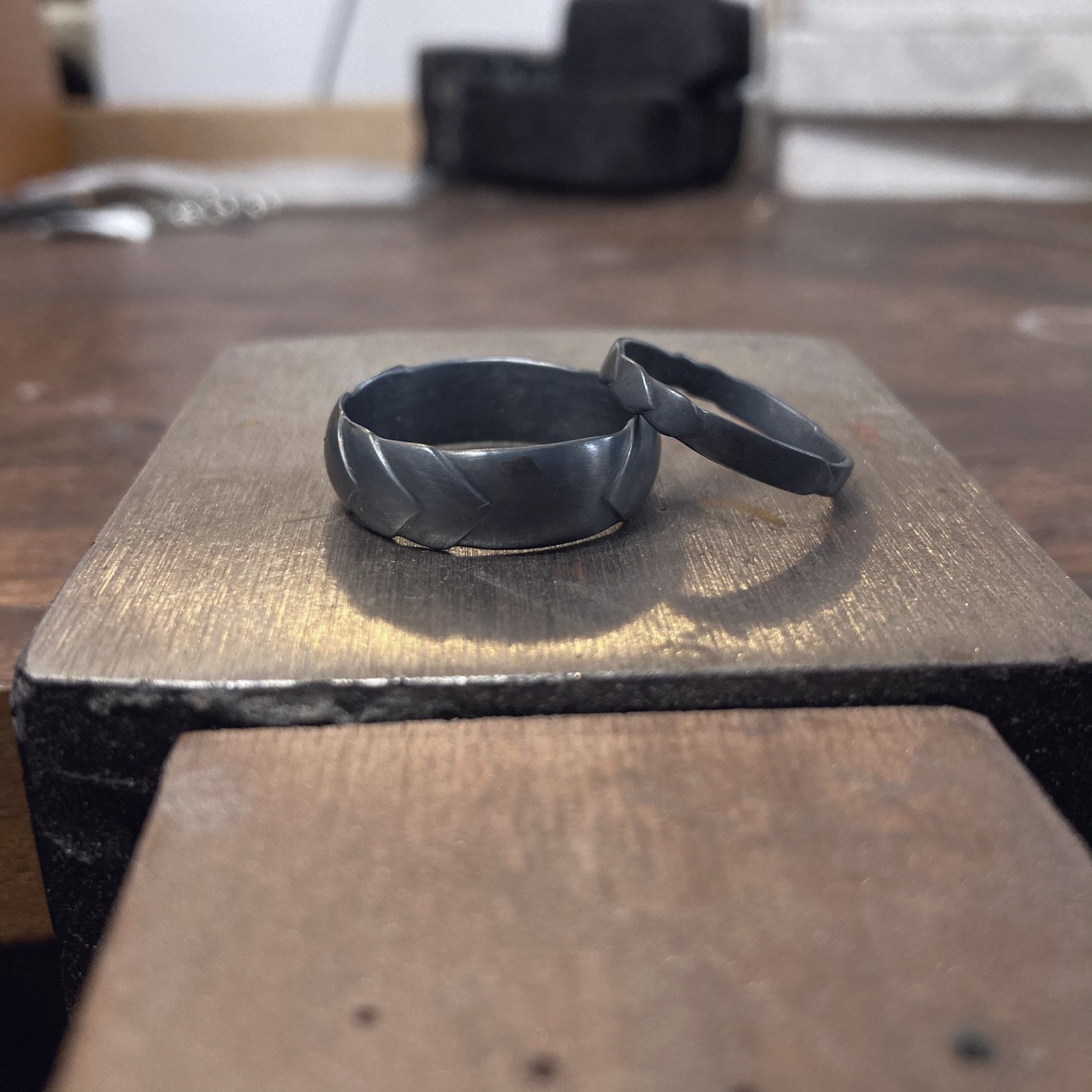 Hand carved 'Feather' design wedding bands in oxidised silver.