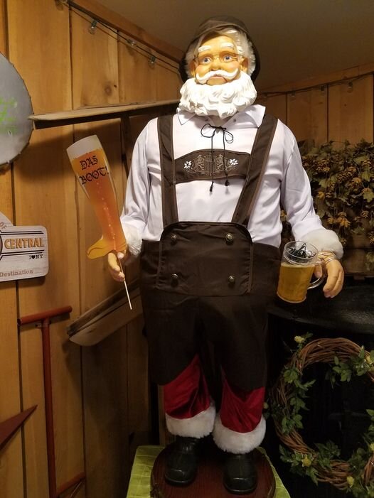 Animated Santa figure wearing German Oktoberfest costume.