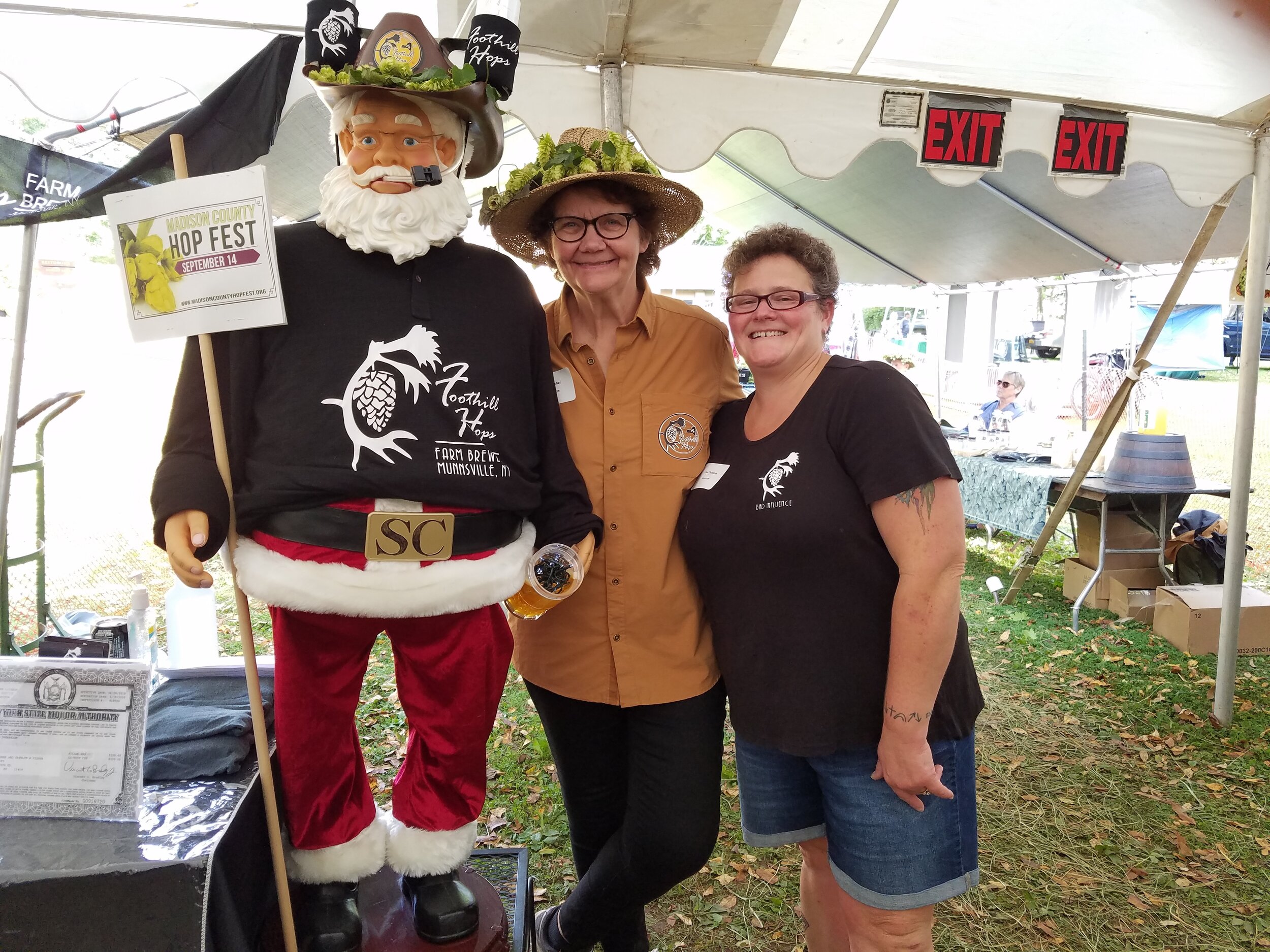 Animated Santa figure, female brewery owner and woman at beer festival.
