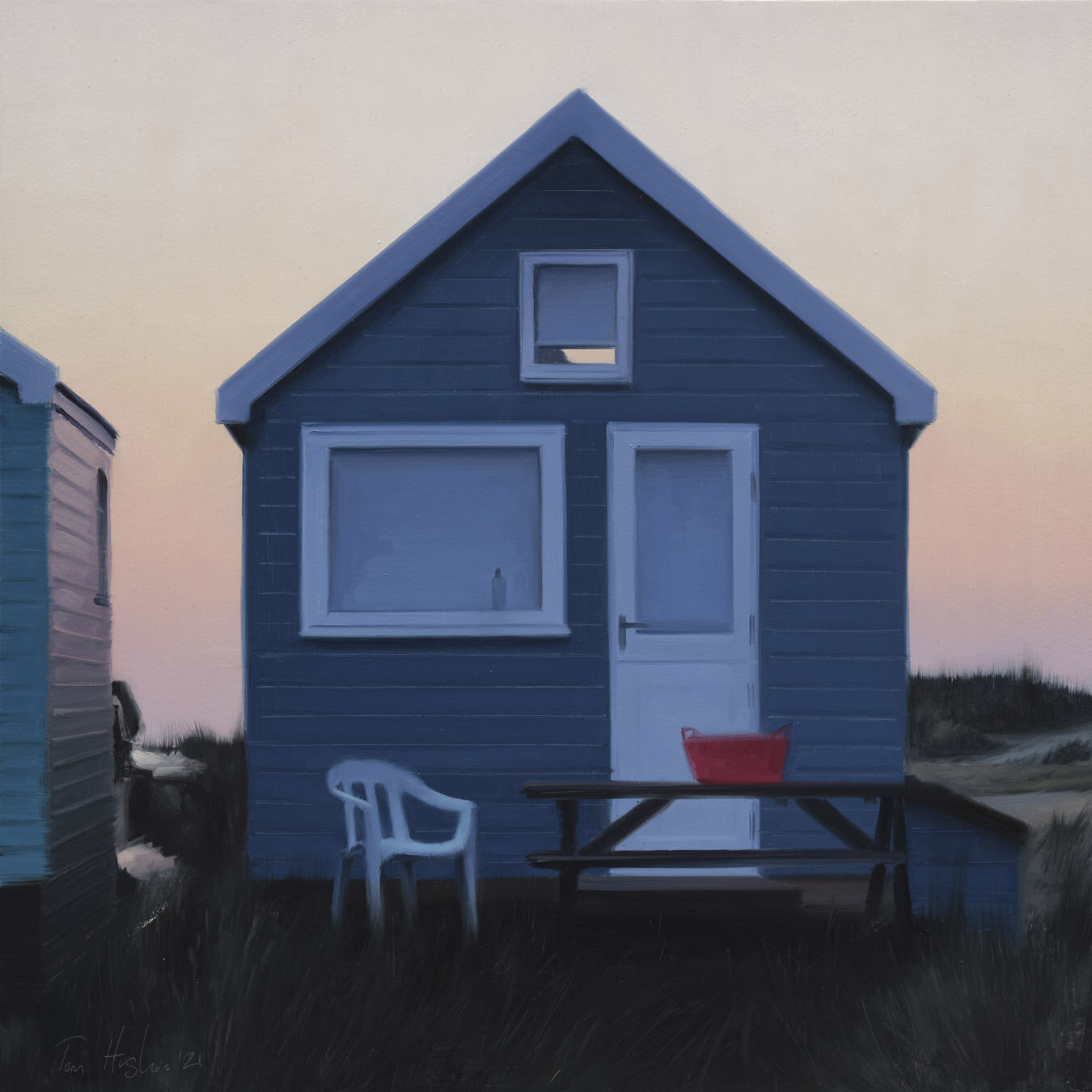 Back-lit blue hut with red tub