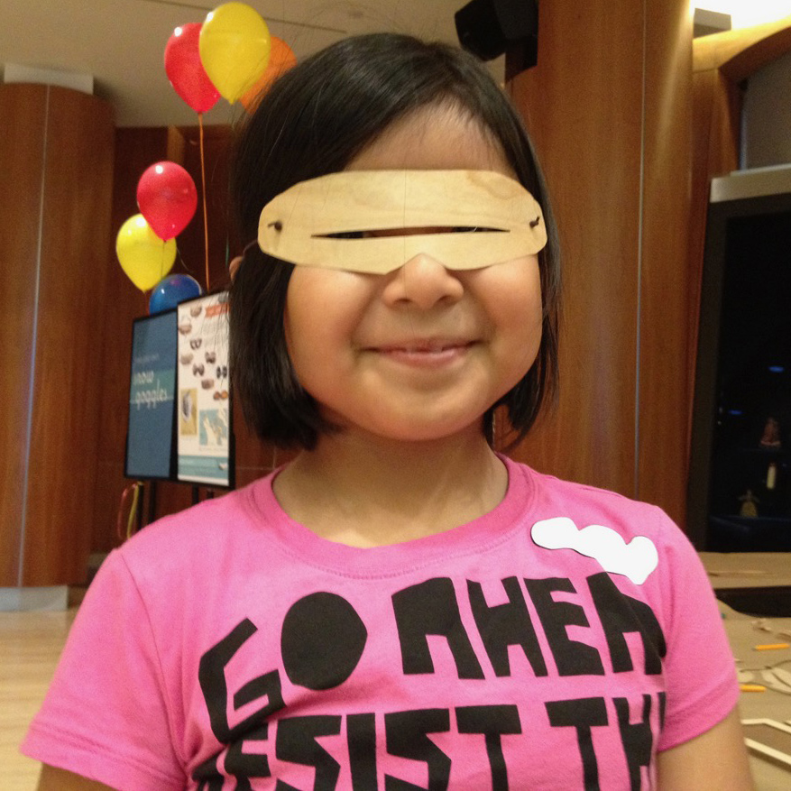 visitor wearing the goggles she made at the Children's Festival at the National Museum of the American Indian