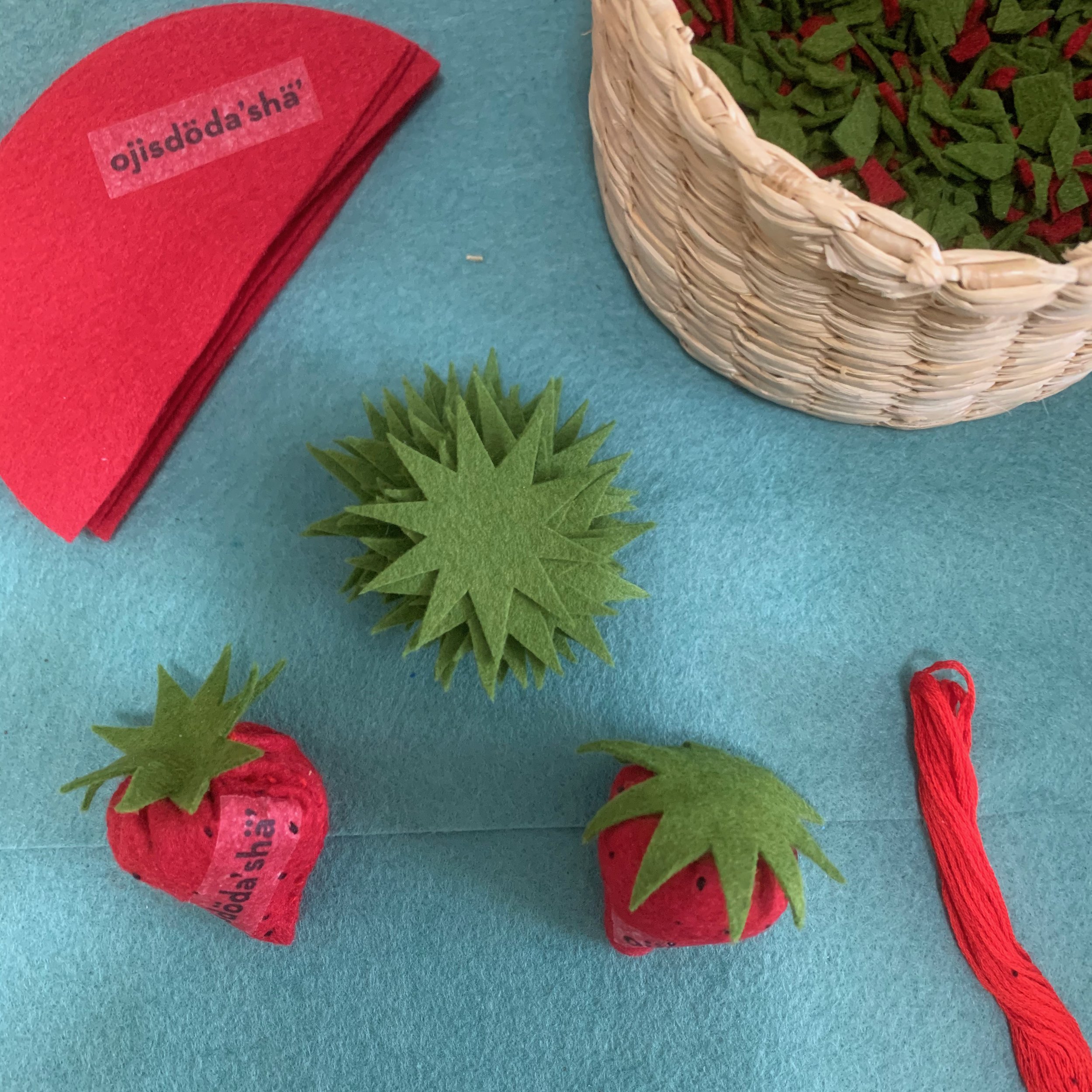  Sewing activity where kids or parents create felt strawberries with the Seneca word ojisdöda’shä’ printed on the felt  