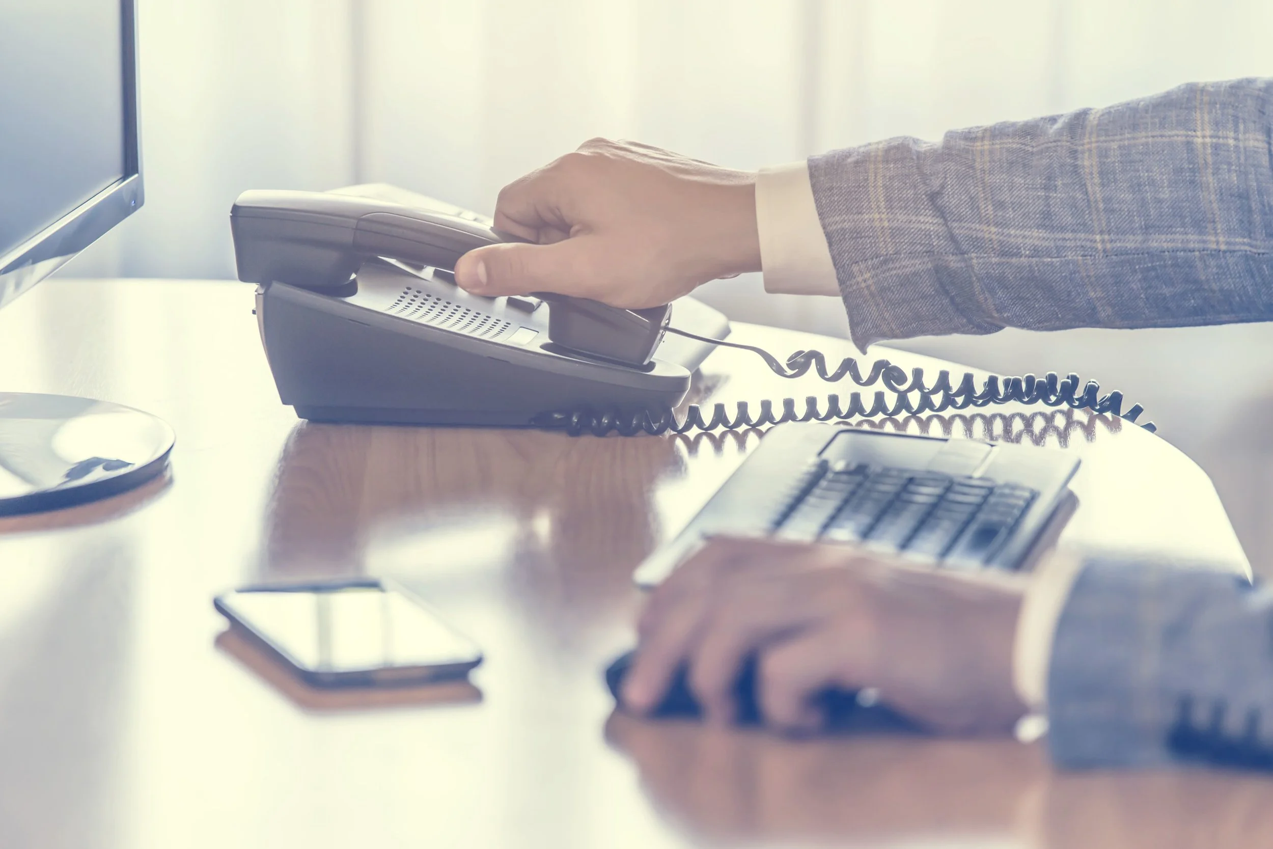 Rizzo-Young-Marketing-LLC-DAK-Services-Inc-Home-Page-Businessman-Desk-Phone-Banner.jpeg