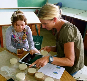 6th–grader Rosemary Bearden and Mandy Lemes making clay ‘ulu