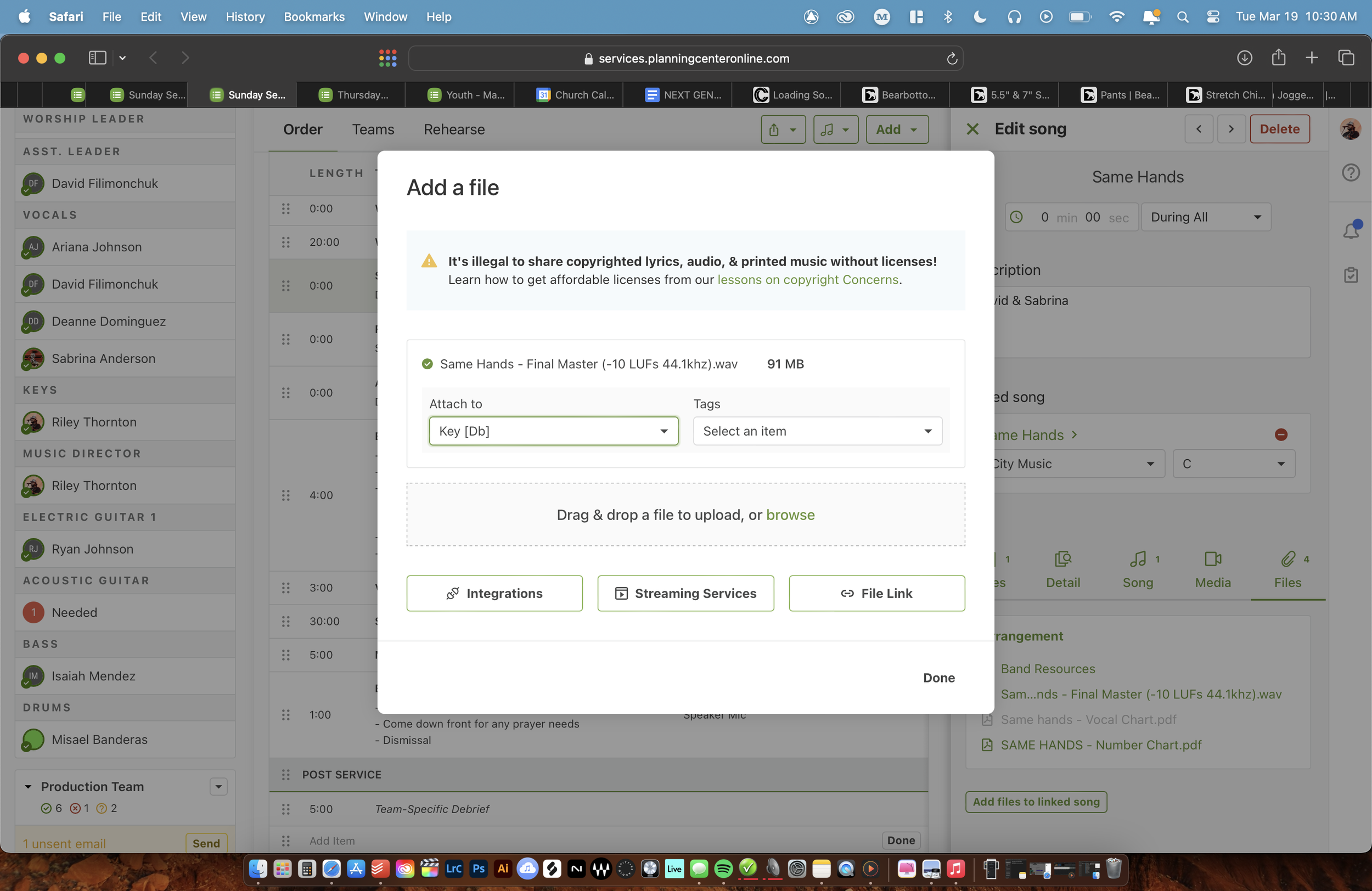A computer screen shows a music management website with a pop-up window titled 'Add a file'. The window displays an audio file named 'Same Hands - Final Master' ready to upload, with options to attach to a key and add tags. The background includes a music scheduling interface with song entries, and a sidebar with team member names and roles.