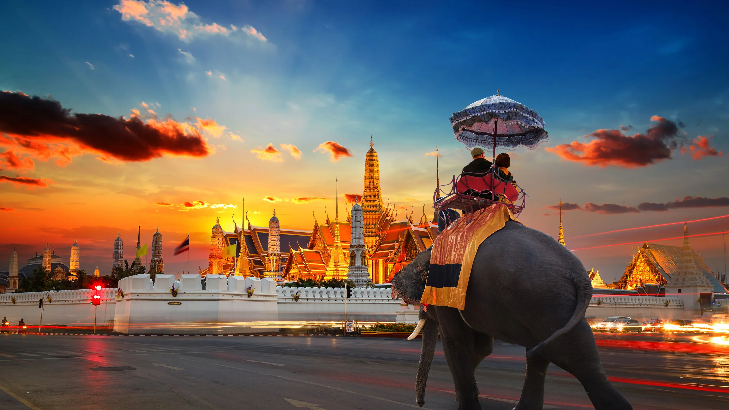 An Elephant with Tourists at Wat Phra Kaew -the Temple of Emerald Buddha- in the Grand Palace of Thailand in Bangkok