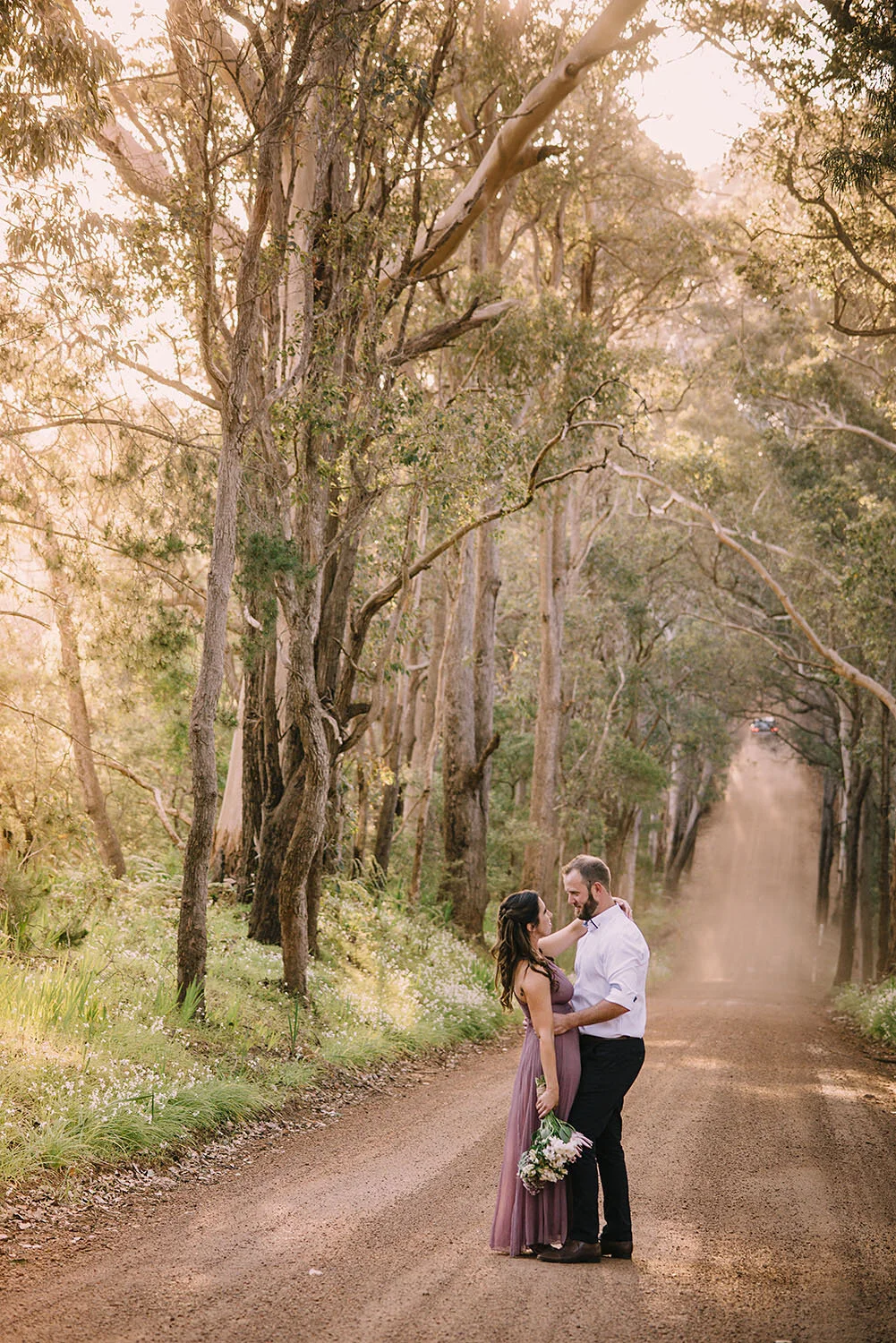 Bride and groom looking at one another in front of stunning Boranup forest backdrop.jpg