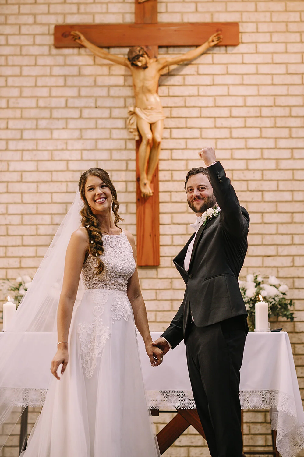 groom clenches fist to celebrate getting married at church
